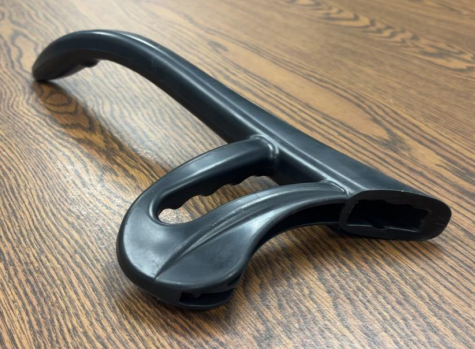 Black bicycle helmet placed on a wooden surface.
