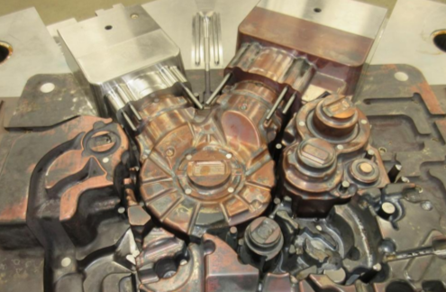 Close-up of a disassembled automotive engine part with various metal components.