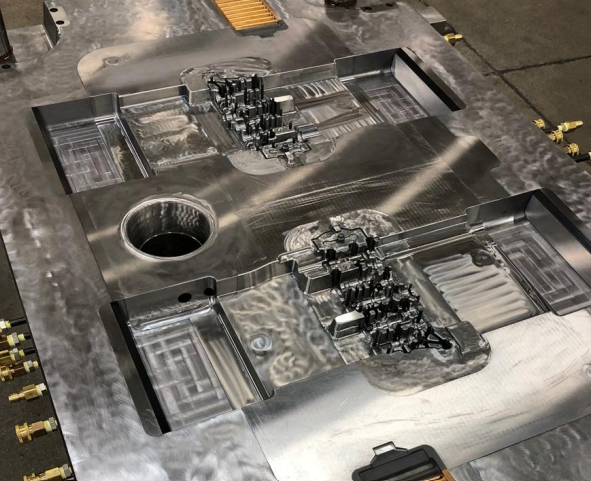 Close-up of a metal mold with intricate details, likely used in manufacturing or metalworking.