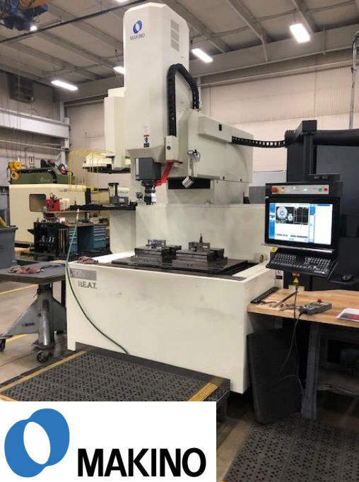 Large Makino CNC machine in an industrial workshop, with computer monitor displaying machining data.