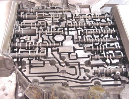 Close-up of a mechanical control panel with numerous interconnected levers and switches.