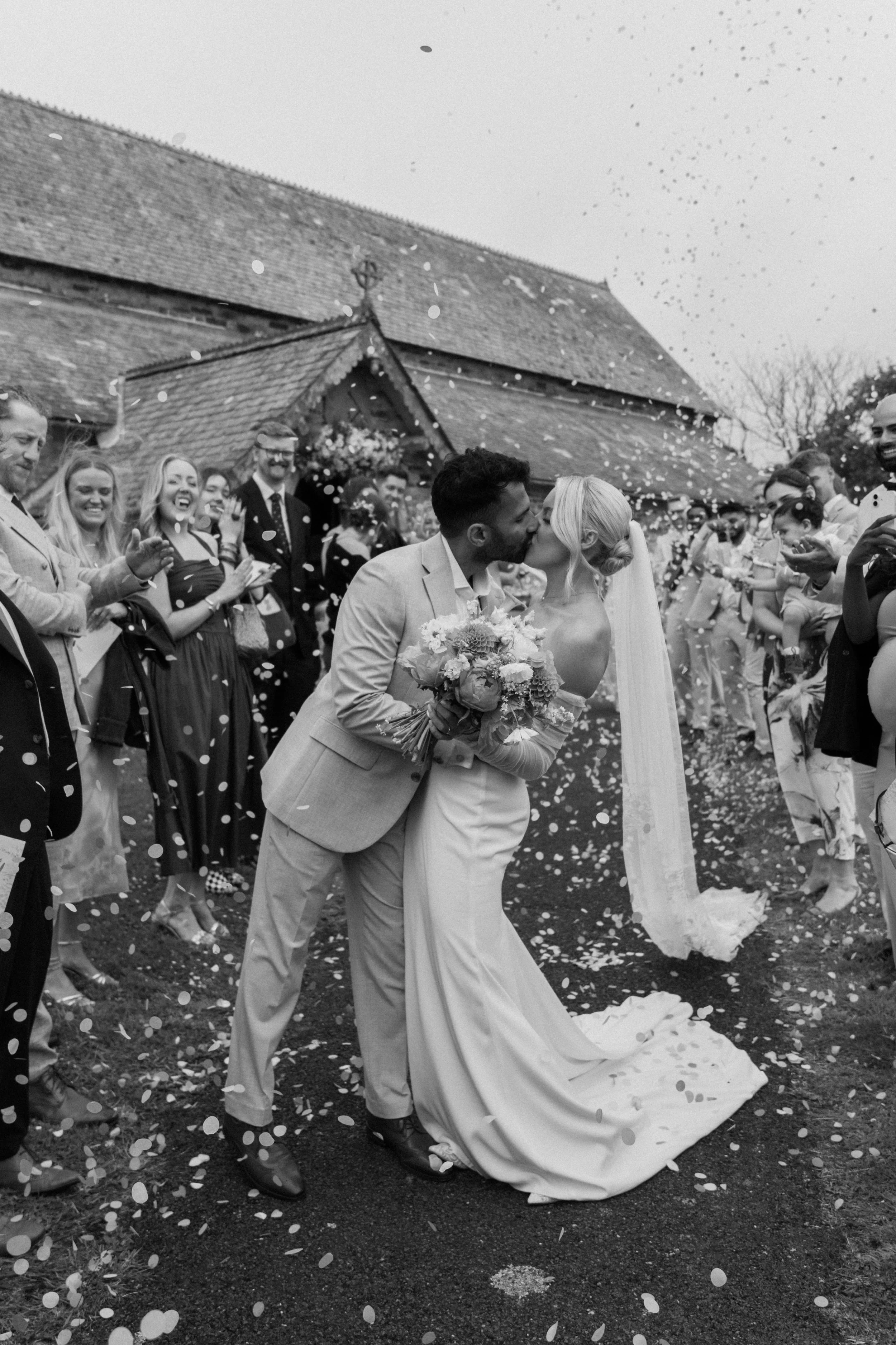 Bride and Groom kissing outside of St Issey Church