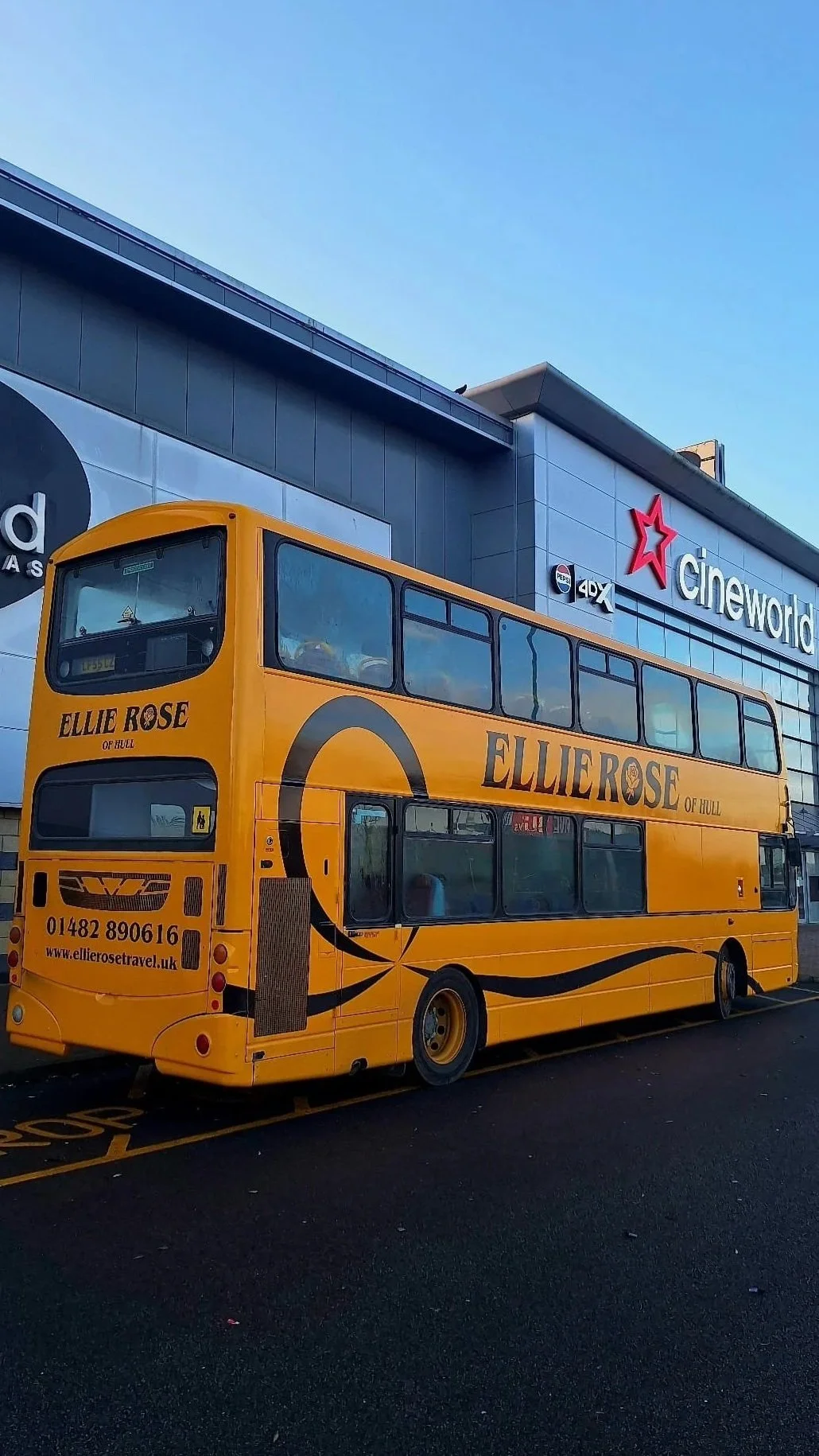 A yellow double-decker bus with advertisement for Ellie Rose of Hull, parked outside a Cineworld movie theater.