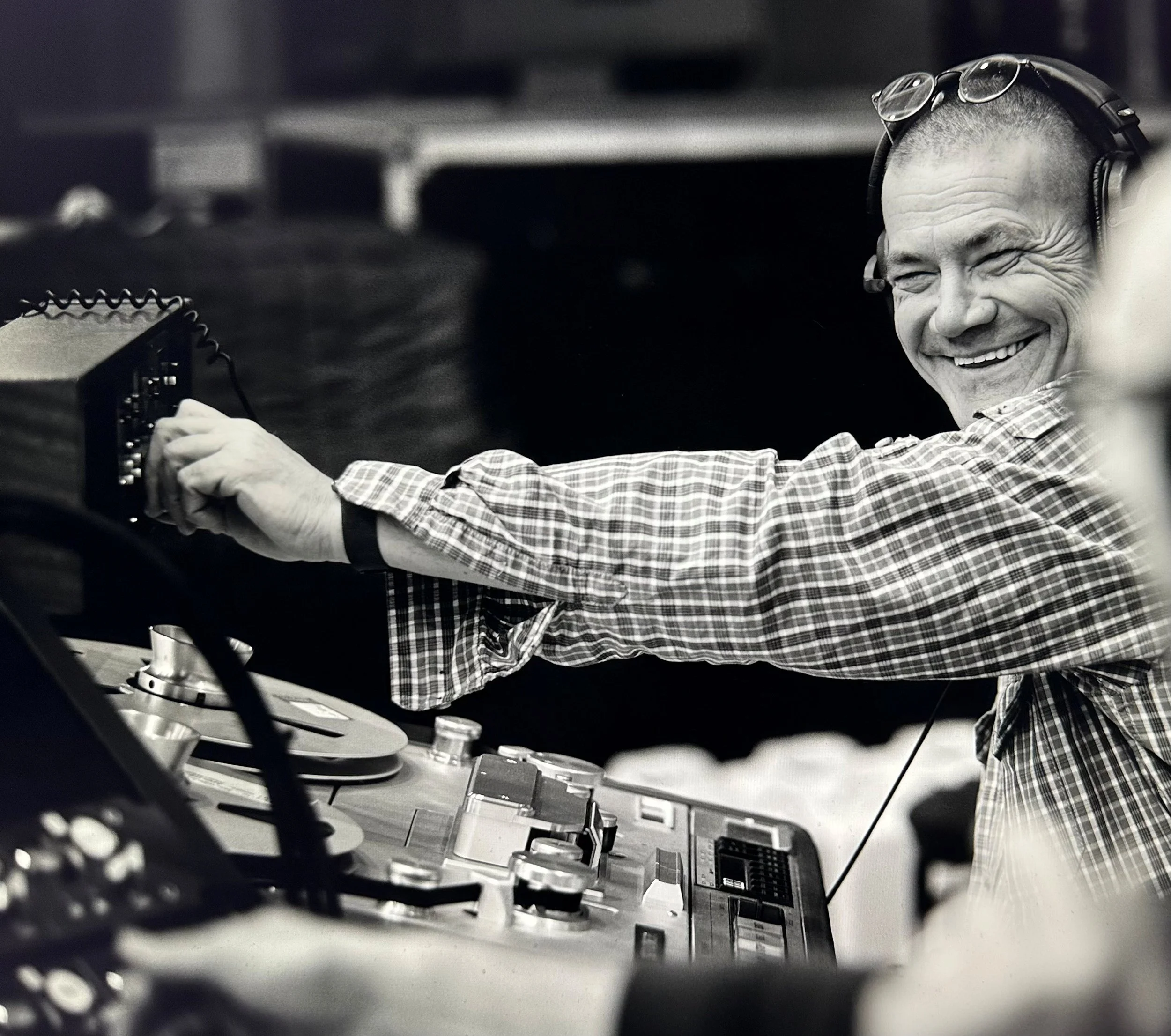 Petronel Butuc, lead audio engineer of Audiophile's Clinic, smiling while operating DJ equipment.