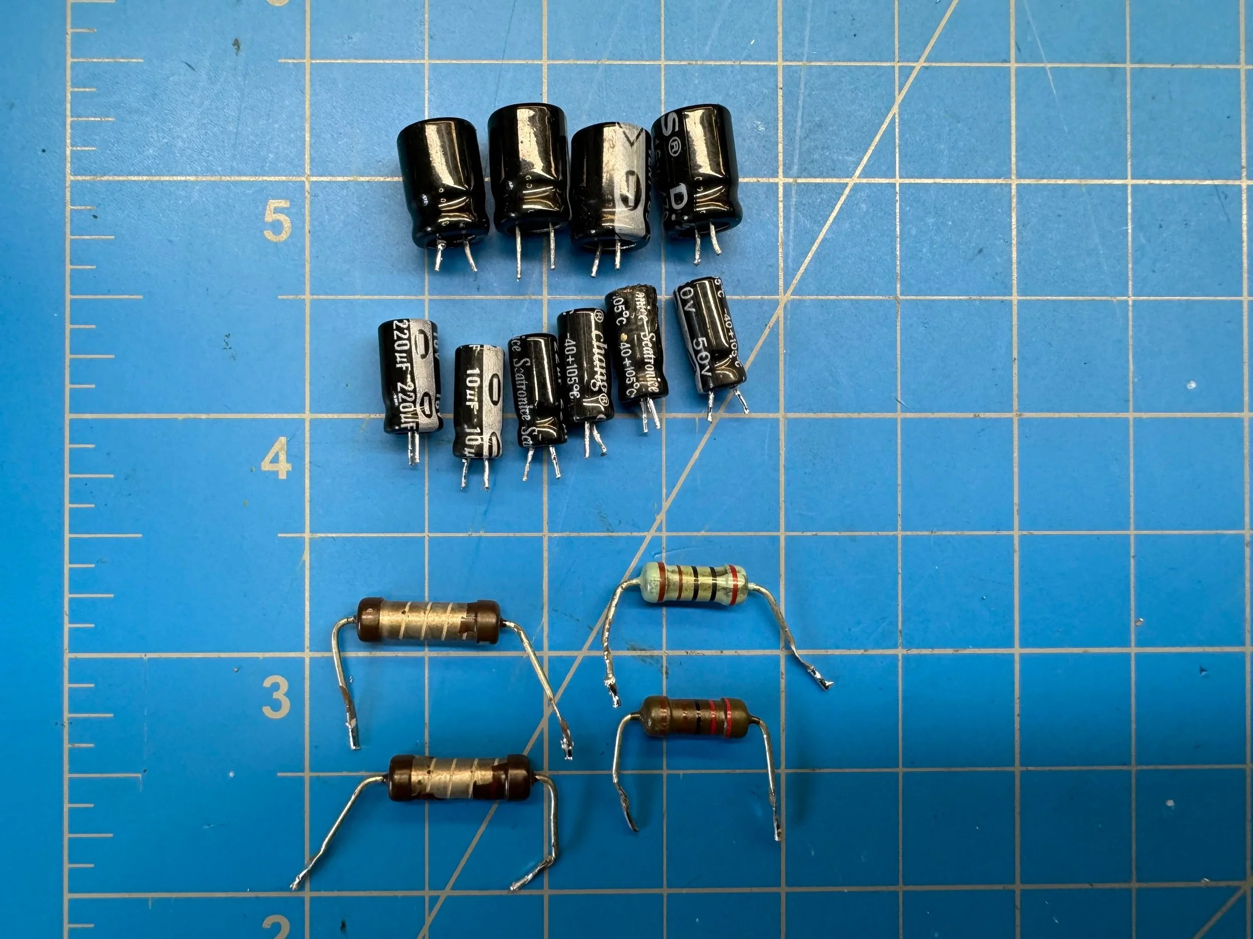 New electrolytic capacitors and replacement resistors installed on the repaired Jamo MPA-101 power supply board.