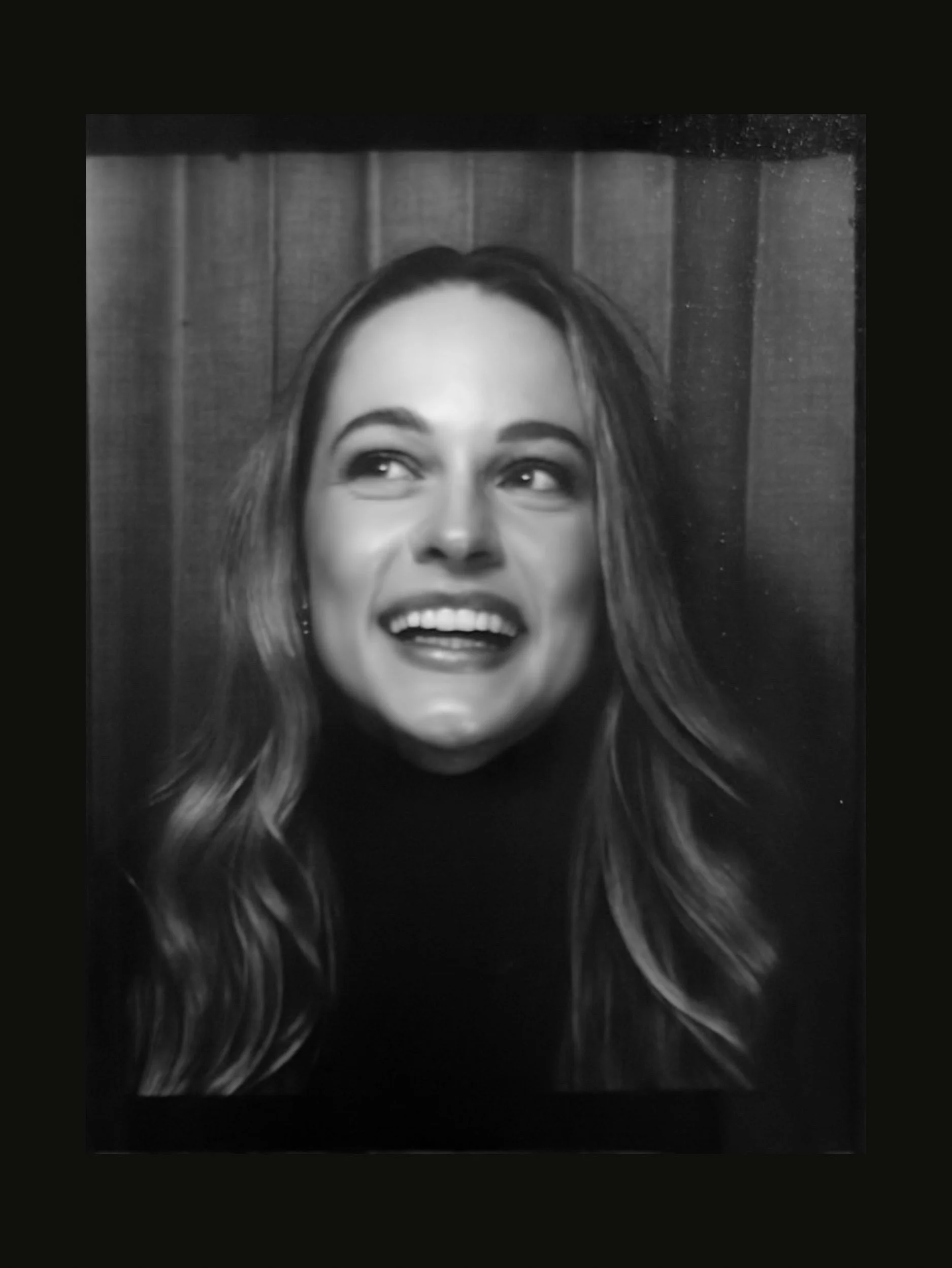 Black and white portrait of Emily Gould, Edinburgh based photographer for weddings, engagement shoots and more, working across film, digital and Super 8mm formats.