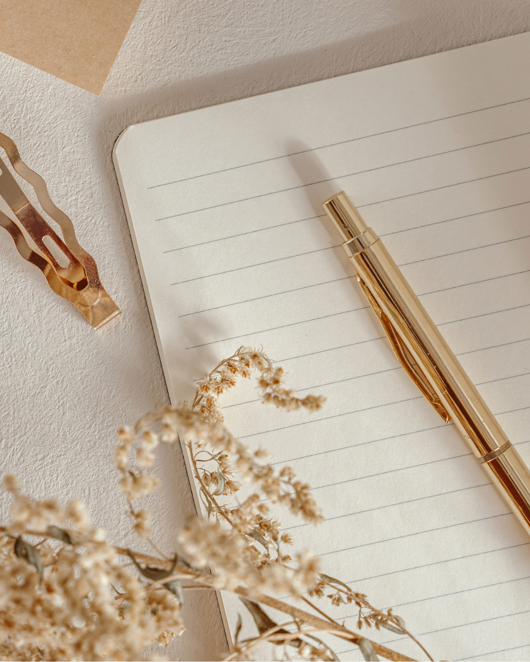 Gold pen on lined notepad paper
