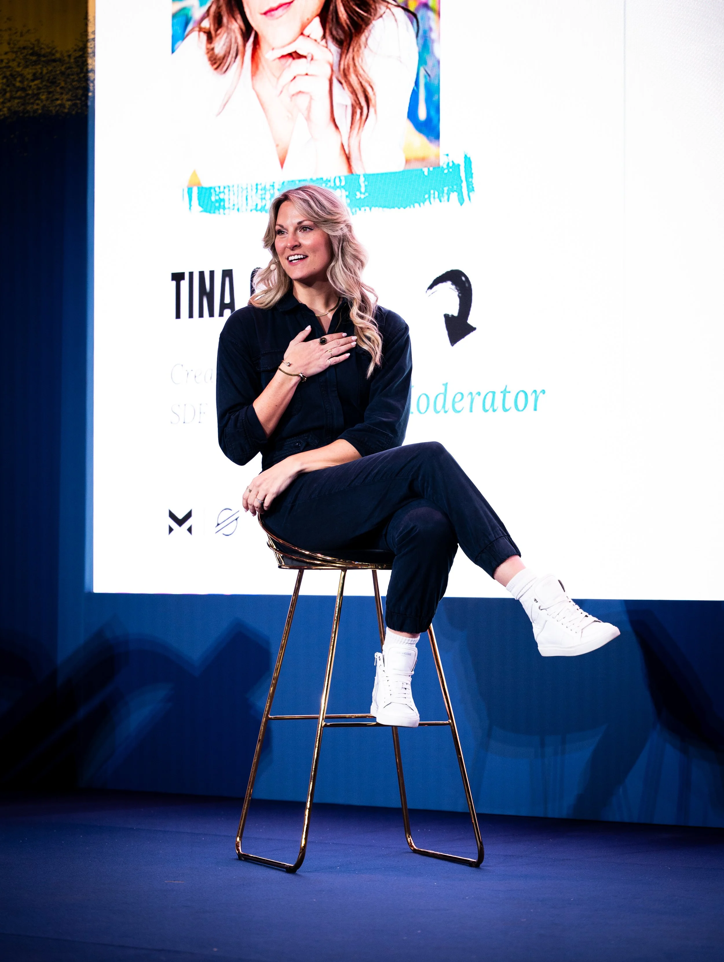 Tina Caye speaking on stage