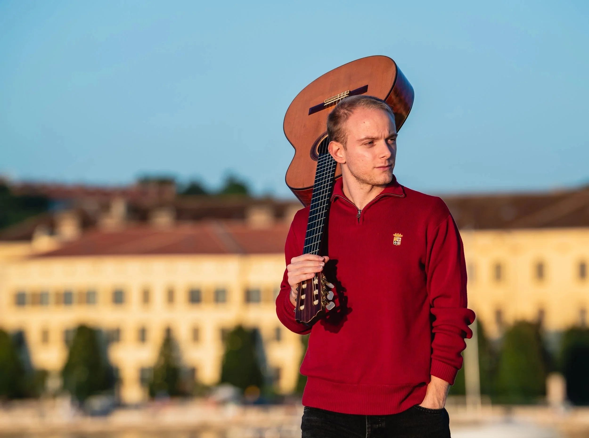 Giovanni Uggeri (Giovanni Uggeri Michelini), classical guitar over his shoulder, standing in Rovinj (Rovigno) Croatia