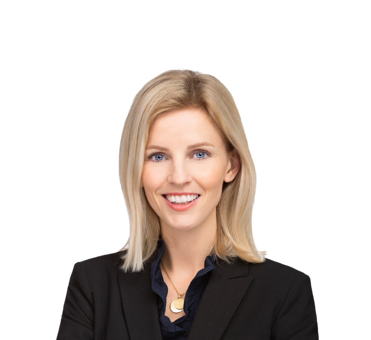 Confident blonde woman in black blazer with arms crossed, smiling against a plain background.
