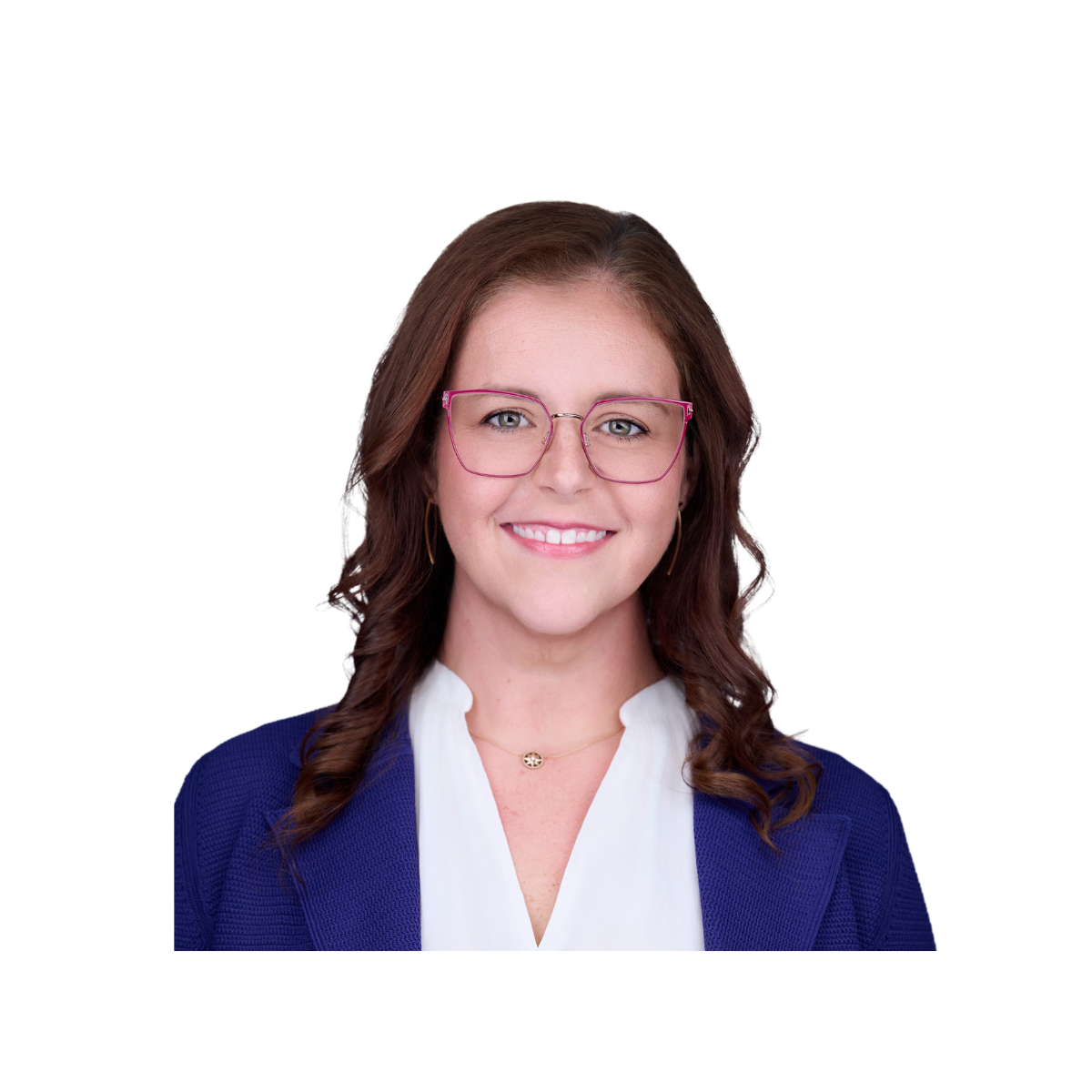 A woman with brown hair, wearing pink glasses, a white blouse, a blue blazer, and gold jewelry, smiling at the camera.