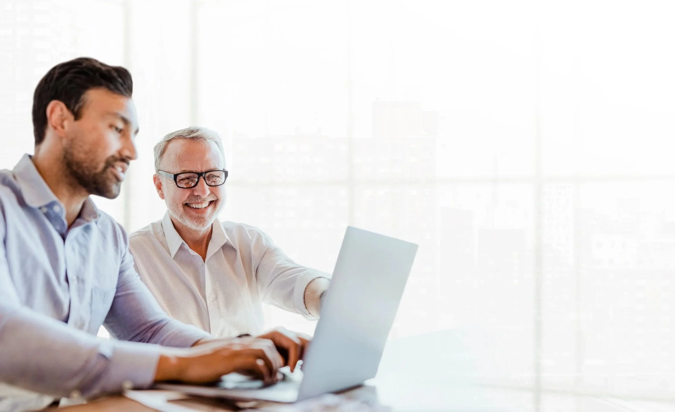 Black and white photo of people sitting in a row at a conference, clapping, with visible attendee badges.