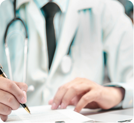 Doctor in white coat writing on a clipboard
