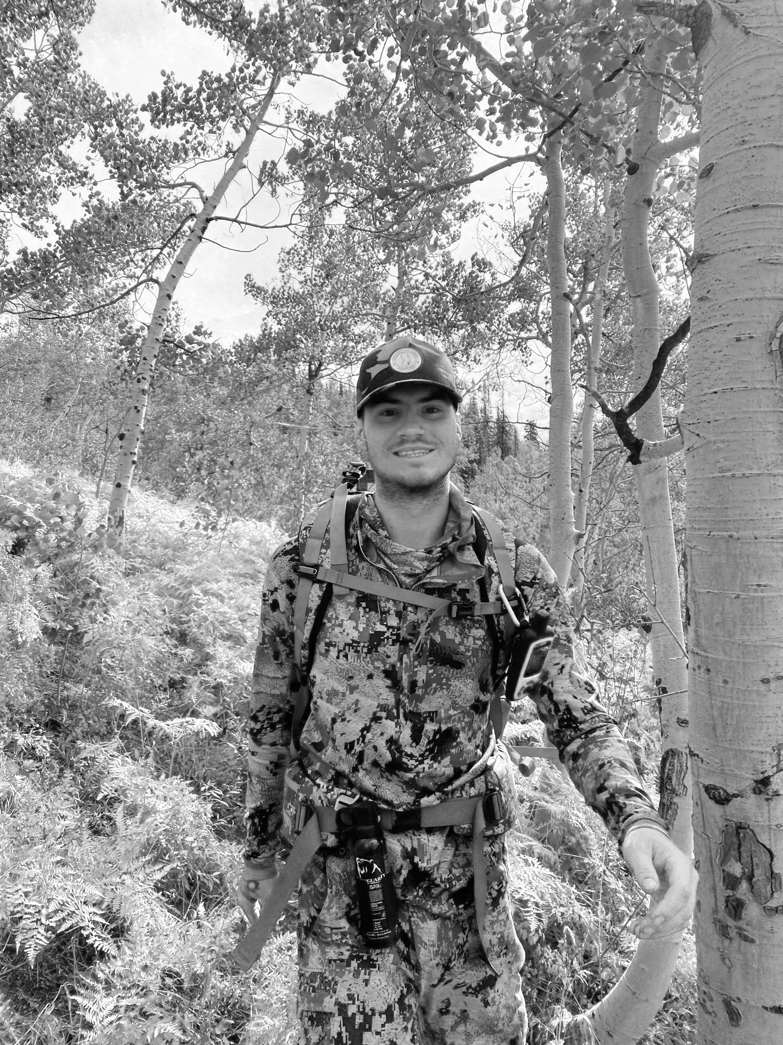 A hunter in a western forest, black and white.