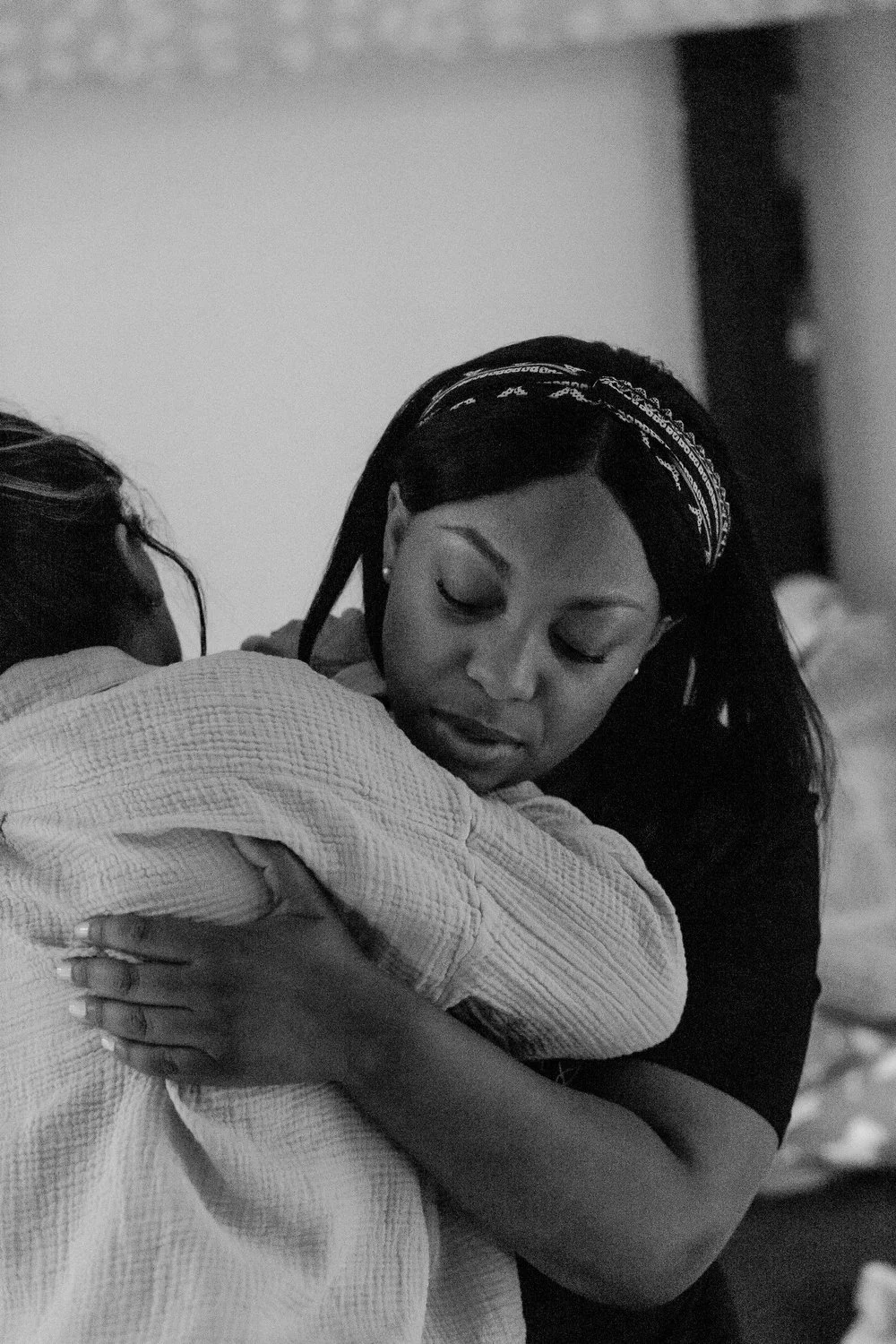 Bree Stallings, certified doula, at postpartum visit, Detroit, MI, assisting a mother during birth