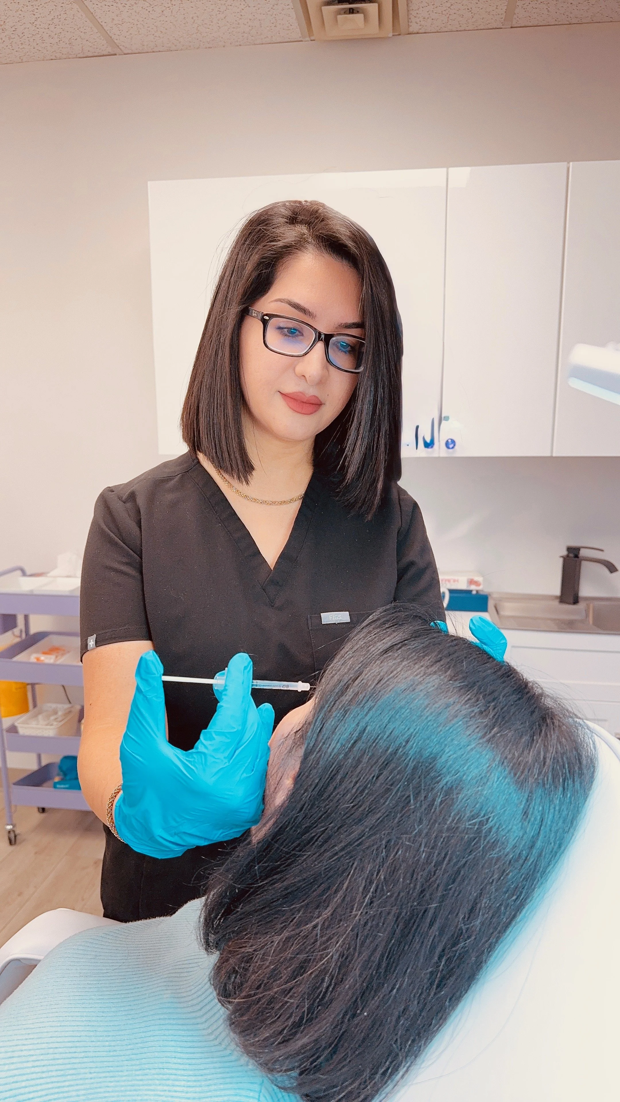 A healthcare professional administering a vaccination or injection to a patient in a clinical setting.