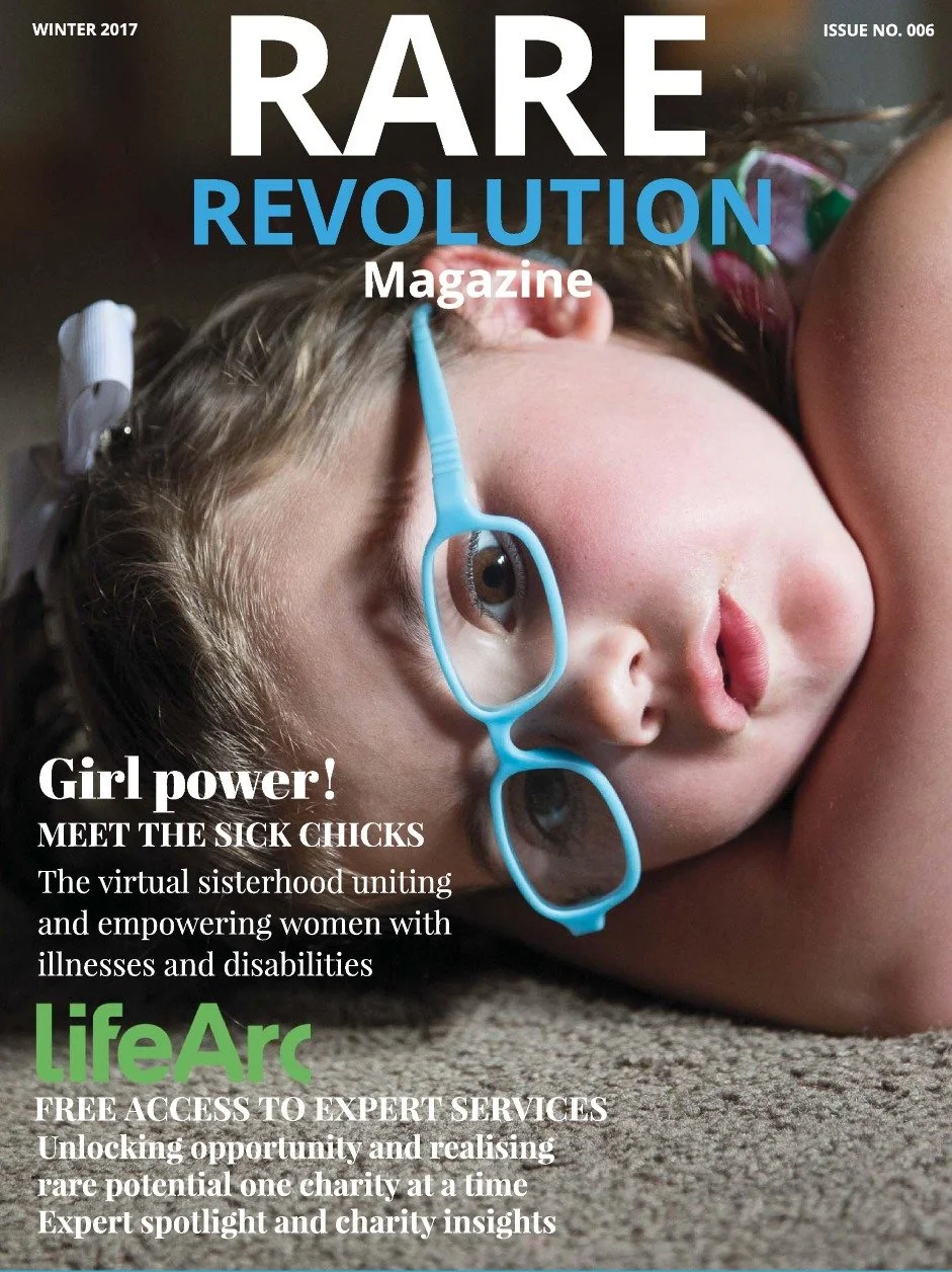 Cover of Rare Revolution magazine featuring a young girl lying on the floor with blue glasses on her face, looking contemplative.