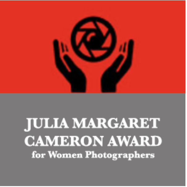 Logo with red background, black hands holding a camera shutter icon, and gray section with white text reading "Julia Margaret Cameron Award for Women Photographers."