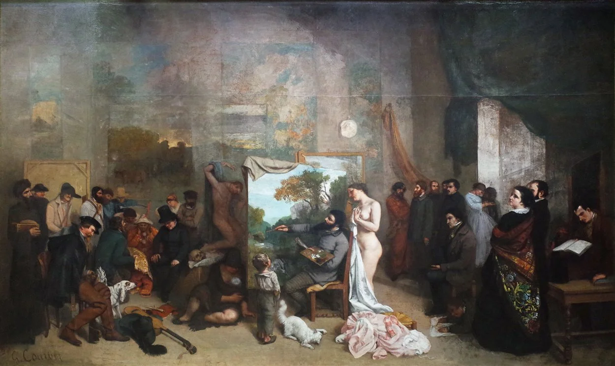 A large group of people gathered in an artist's studio, observing a nude model standing near a seated artist who is painting. The studio has a mix of detailed and unfinished artworks, and the people appear to be engaged in a class or critique.
