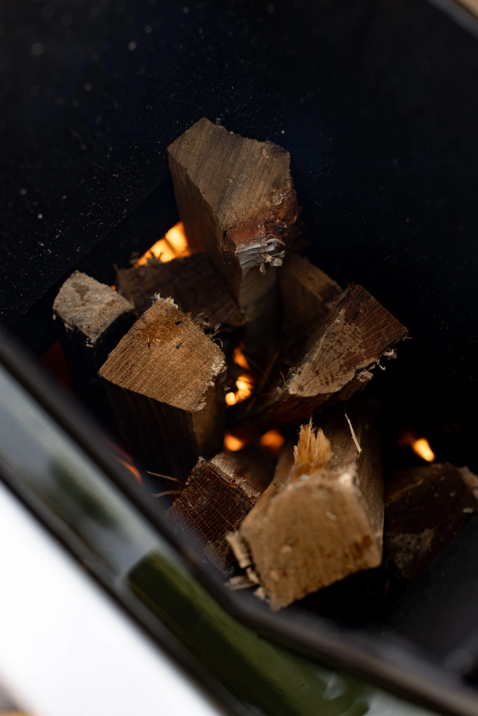 Close-up of wood burning in an aluminum oven inside of a wood fired aluminum hot tub.