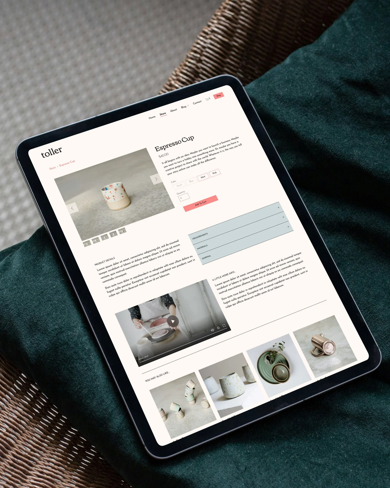An iPad displaying an online shop page for a ceramic espresso cup, placed on a person's lap with a green cloth and wicker chair in the background.