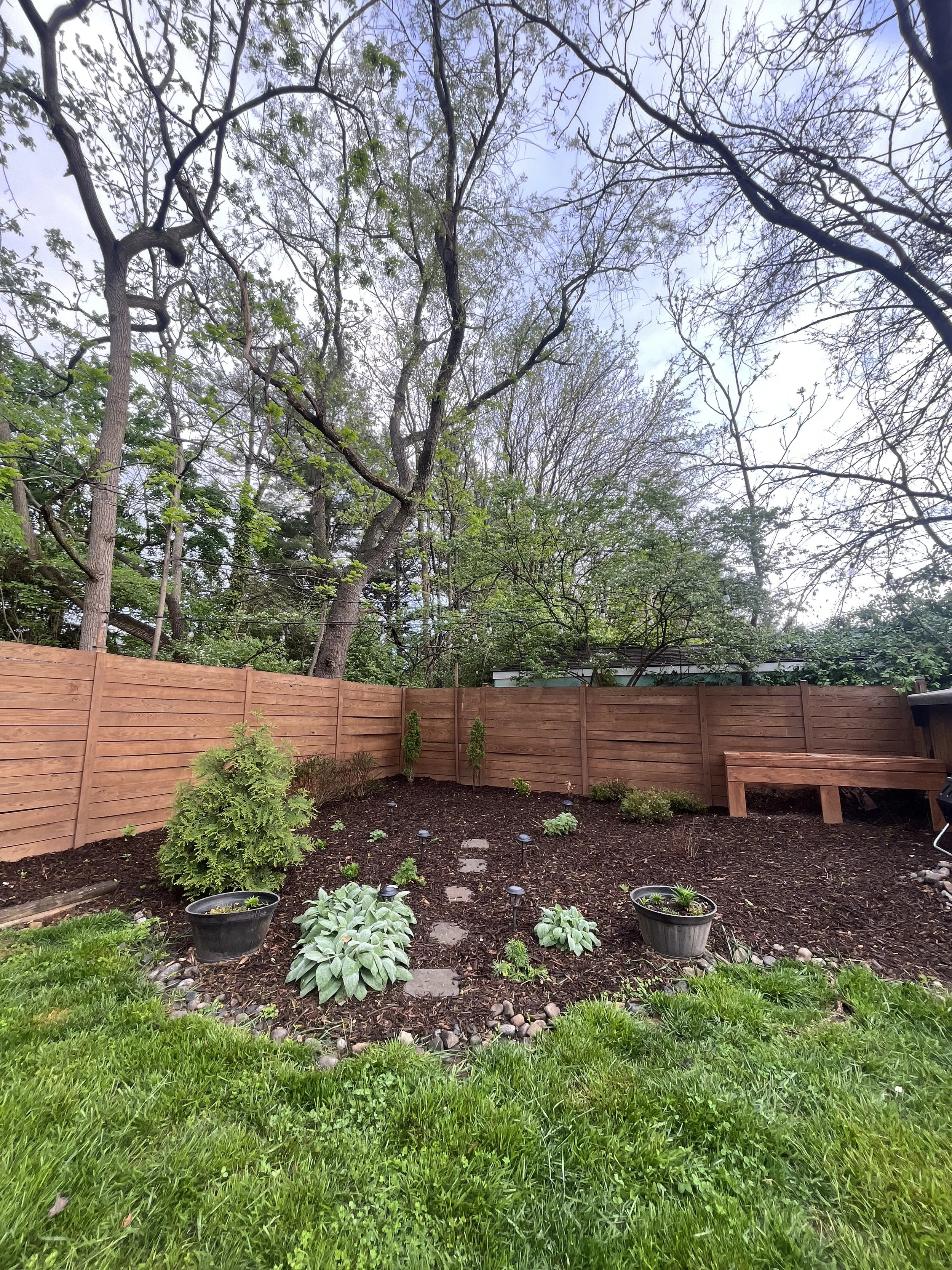 Mulched flower bed with compost bin