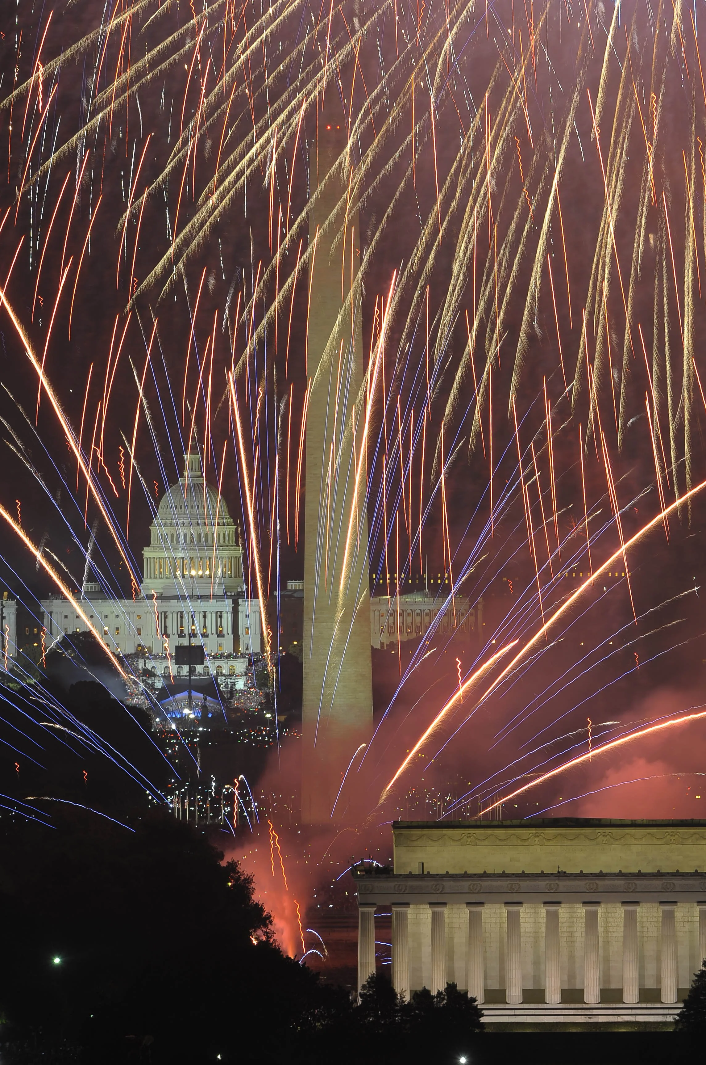 Fireworks display over the U.S. Capitol building at night.