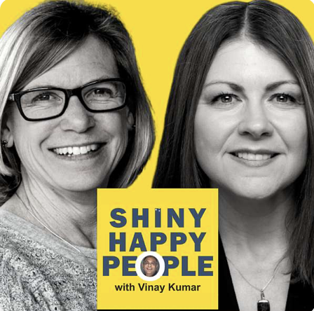 Two women smiling in a split black-and-white portrait with a bright yellow background. A yellow box in the center contains the text 'SHINY HAPPY PEOPLE with Vinay Kumar' and a small image of a person.