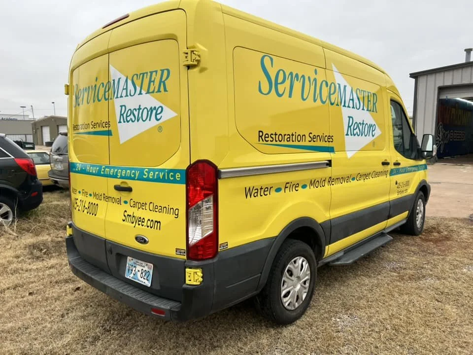 outside view of the Bright yellow and green servicemaster restore branded vehicle wrap