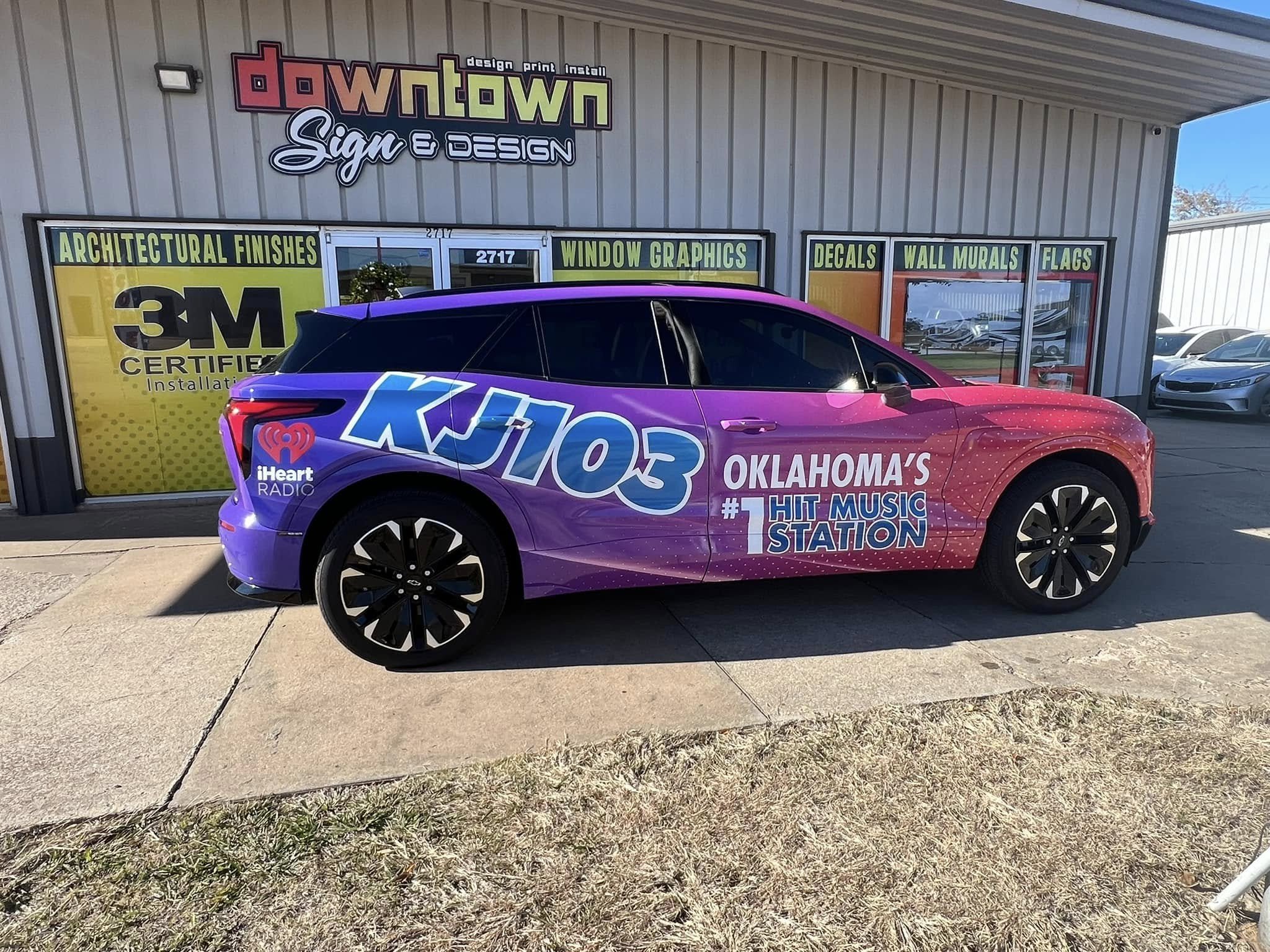 A purple promotional vehicle for KJ103