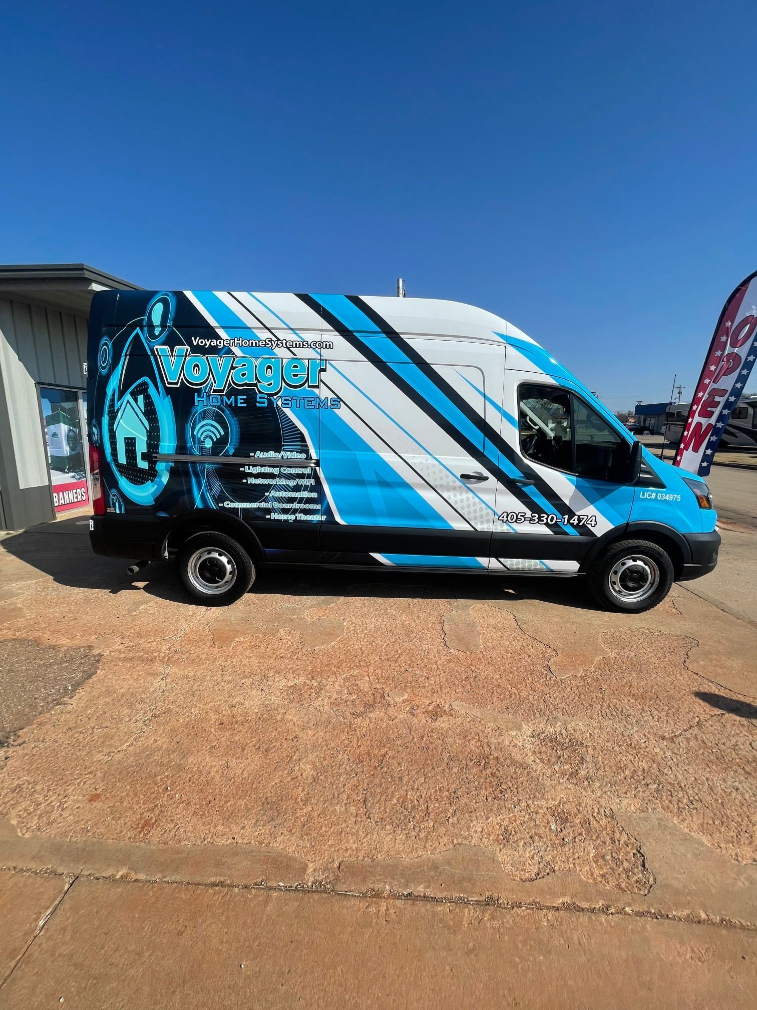 blue black and white vehicle wrap on a van for voyager with stripes