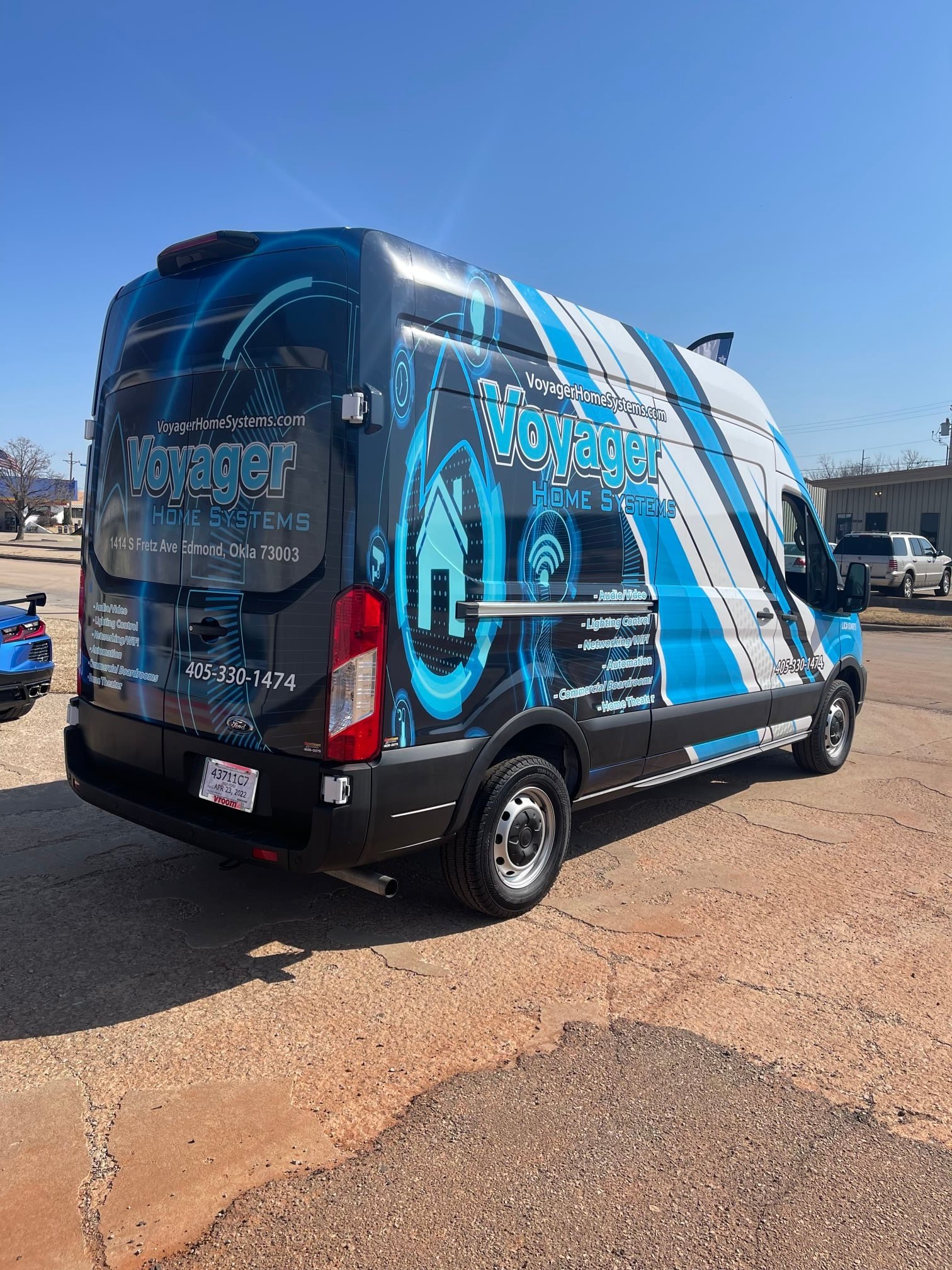 blue black and white vehicle wrap on a van for voyager with stripes