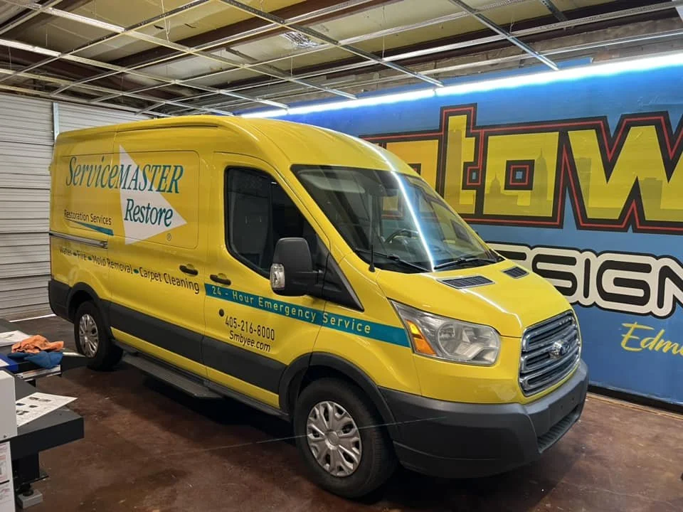 Bright yellow servicemaster restore branded vehicle wrap for advertising. eye catching graphics 