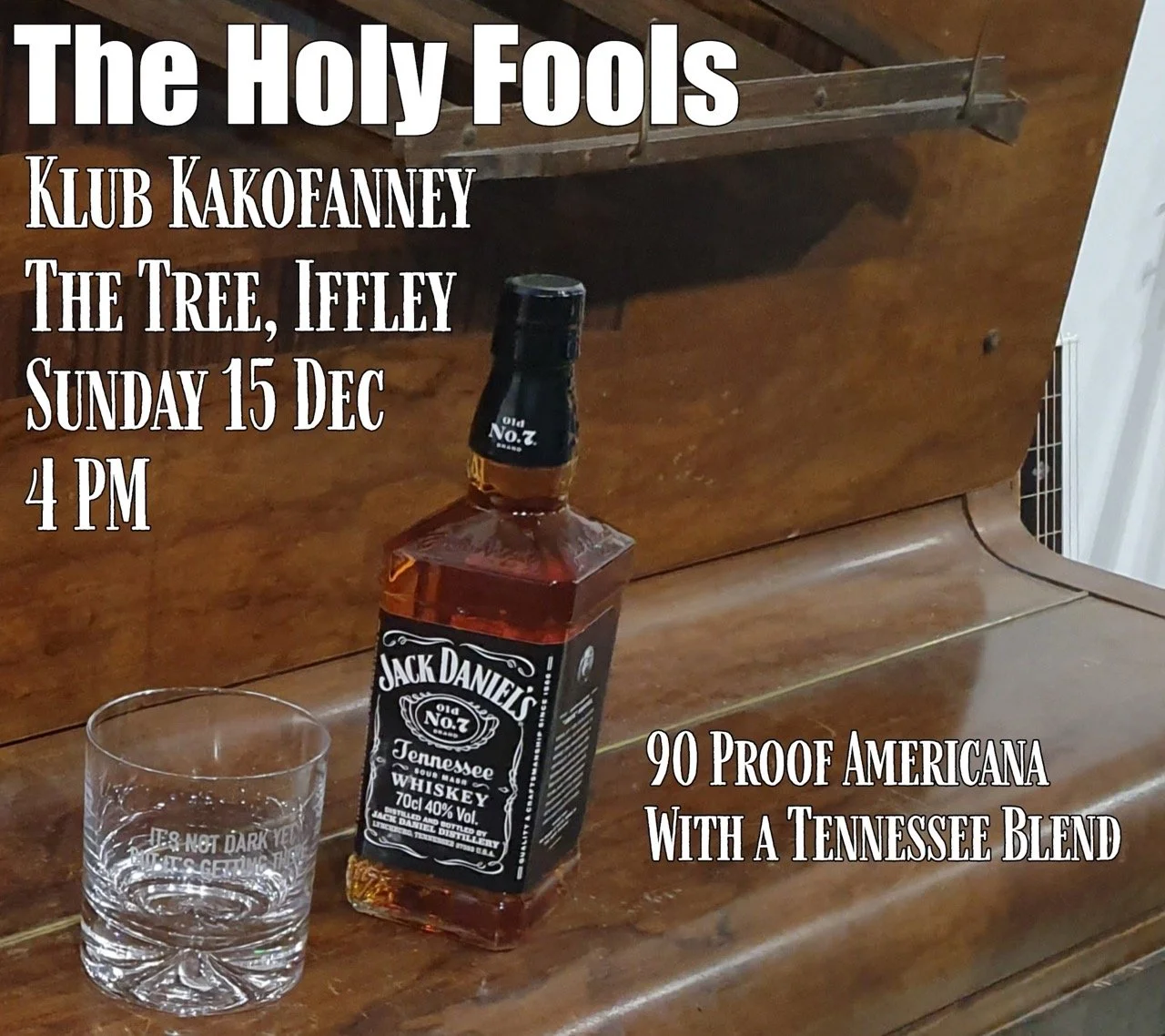 An advertisement for a Holy Fools club event featuring a Jack Daniel's whiskey bottle, placed on a wooden surface with a glass beside it. The text includes event details such as date, time, location, and a note about the whiskey blend.