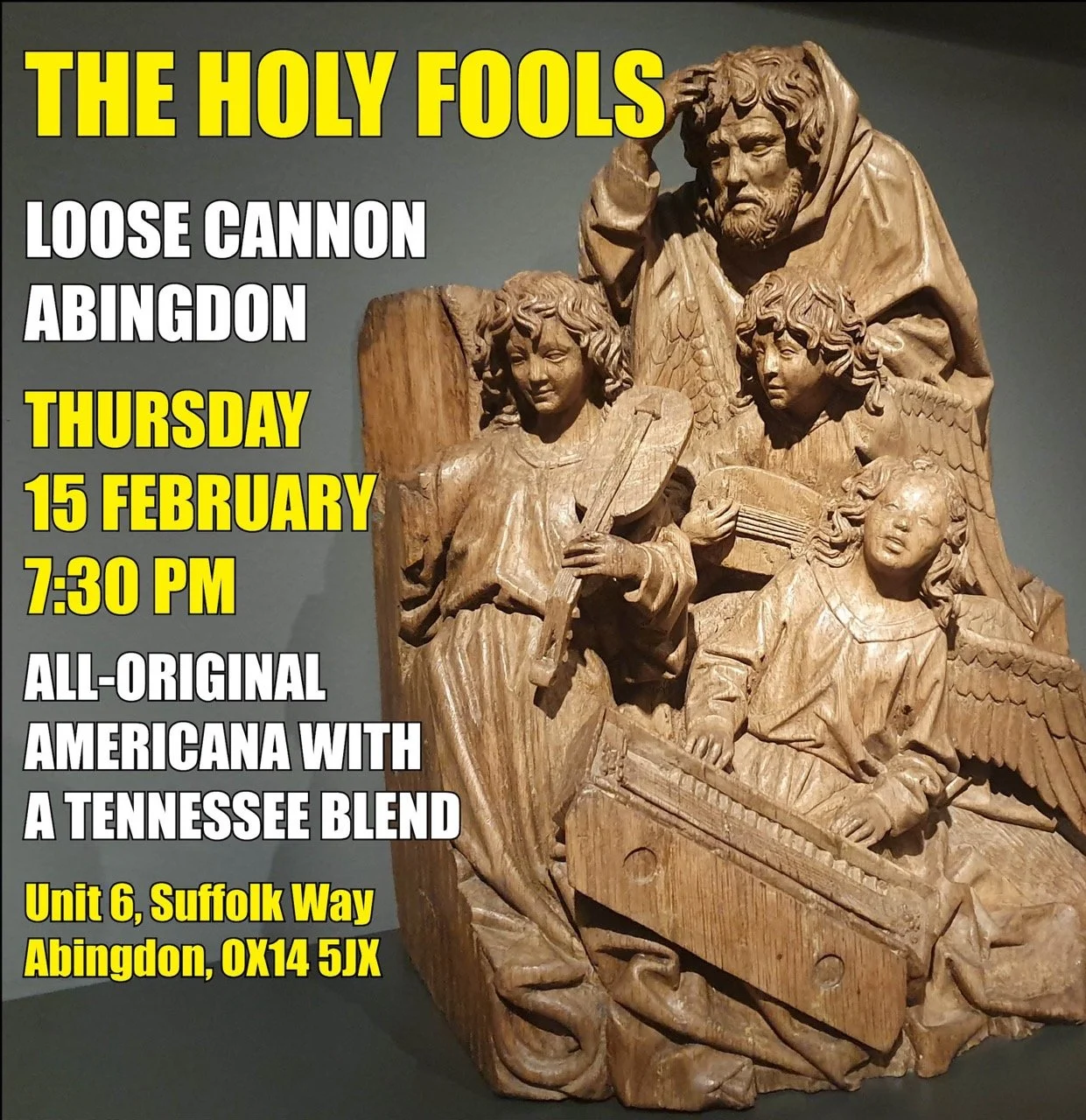 Wooden sculpture of a man with four children, one of whom has wings; the children are playing musical instruments and the man appears contemplative.