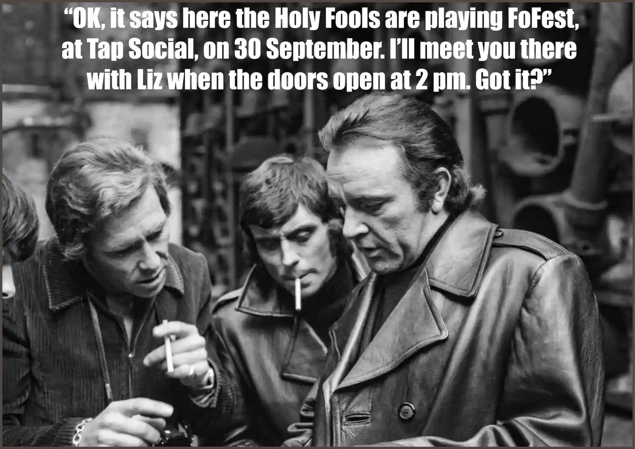 A black and white photo of three men, one with long hair and leather jacket, another with short hair and cigarette, all looking at something together. There is white text at the top of the image with a quote about a music event.