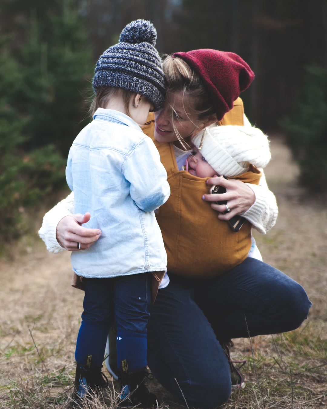 Parent embracing child outdoors representing family connection and parenting support in therapy