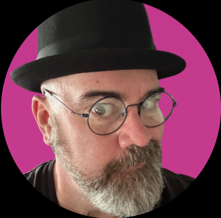A man wearing a black top hat and round glasses with a pink background.