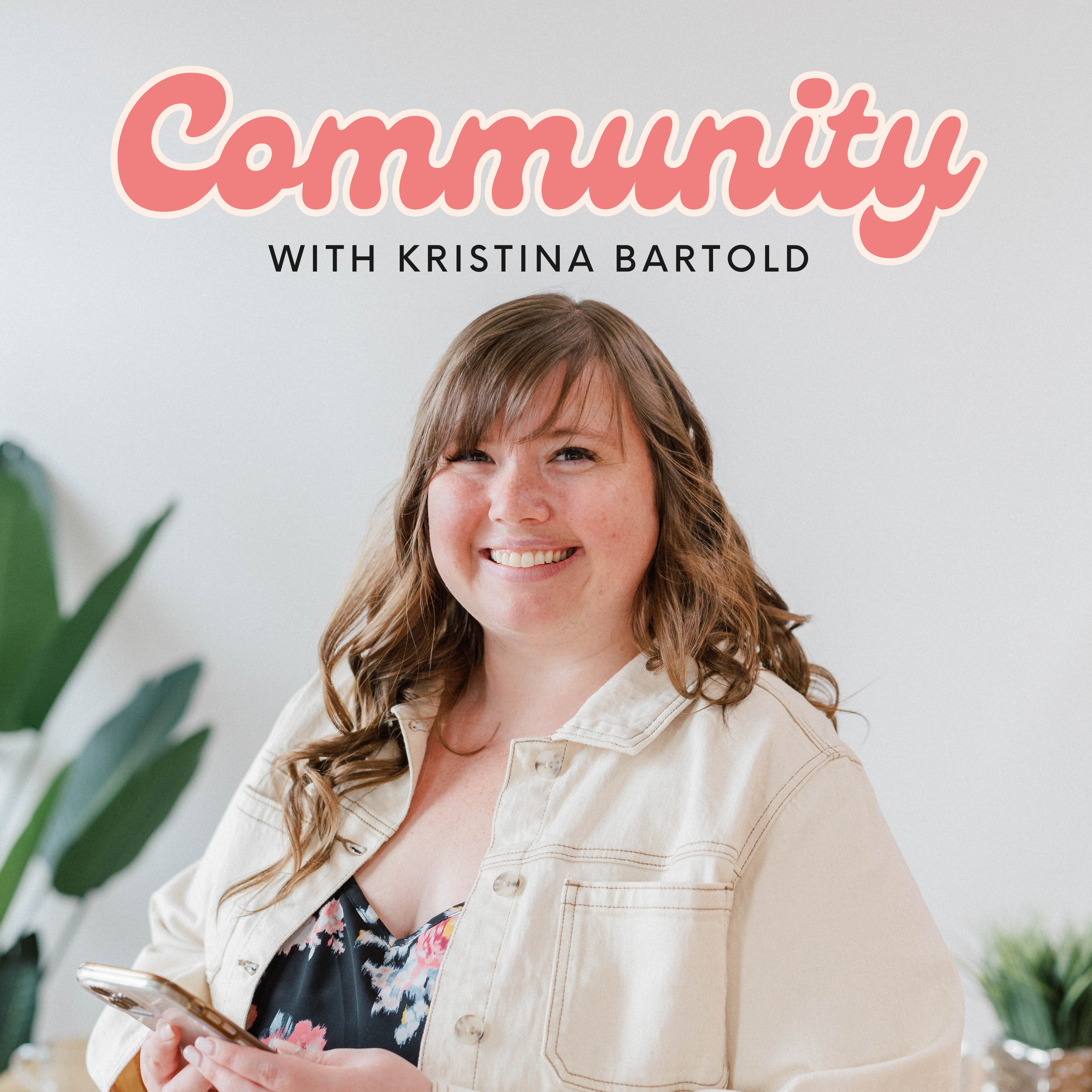 A smiling woman with long, wavy brown hair holding a smartphone in her hand, standing in a room with green plants and a white background. The image is promoting a podcast or titled 'Community with Kristina Bartold.'