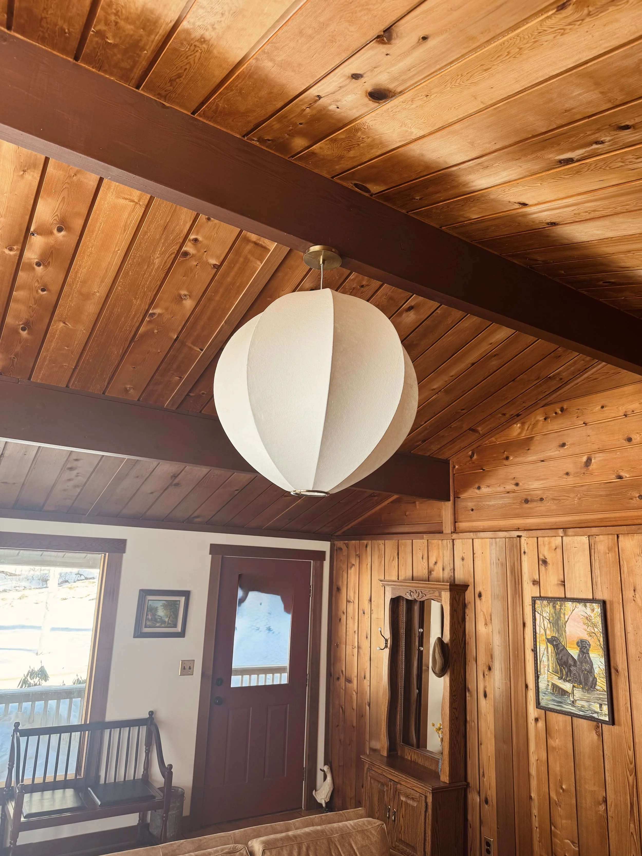 large orb pendant light fixture warm glow living room