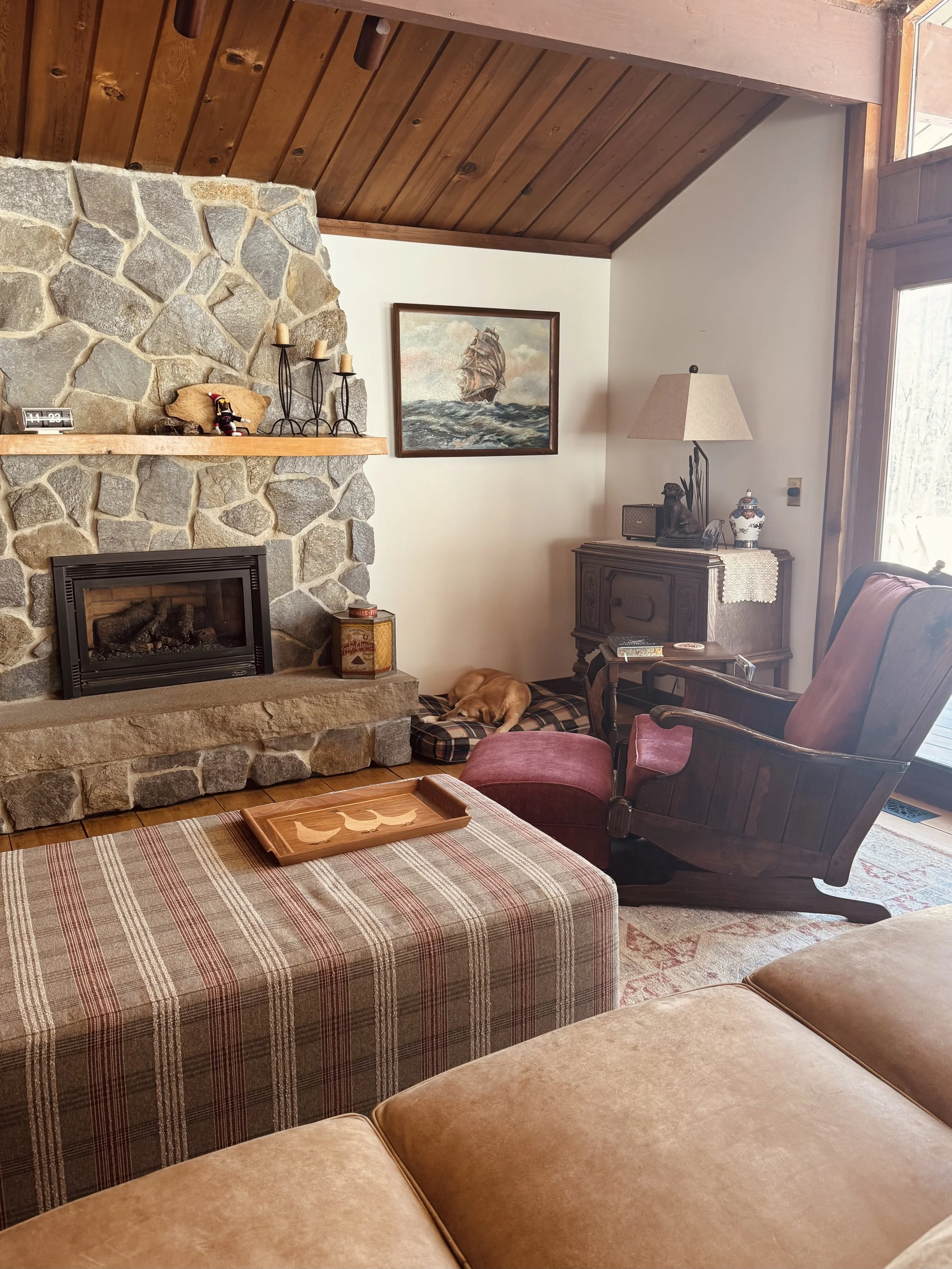 stone fireplace plaid ottoman rustic cozy rocking chair vintage antique cabin