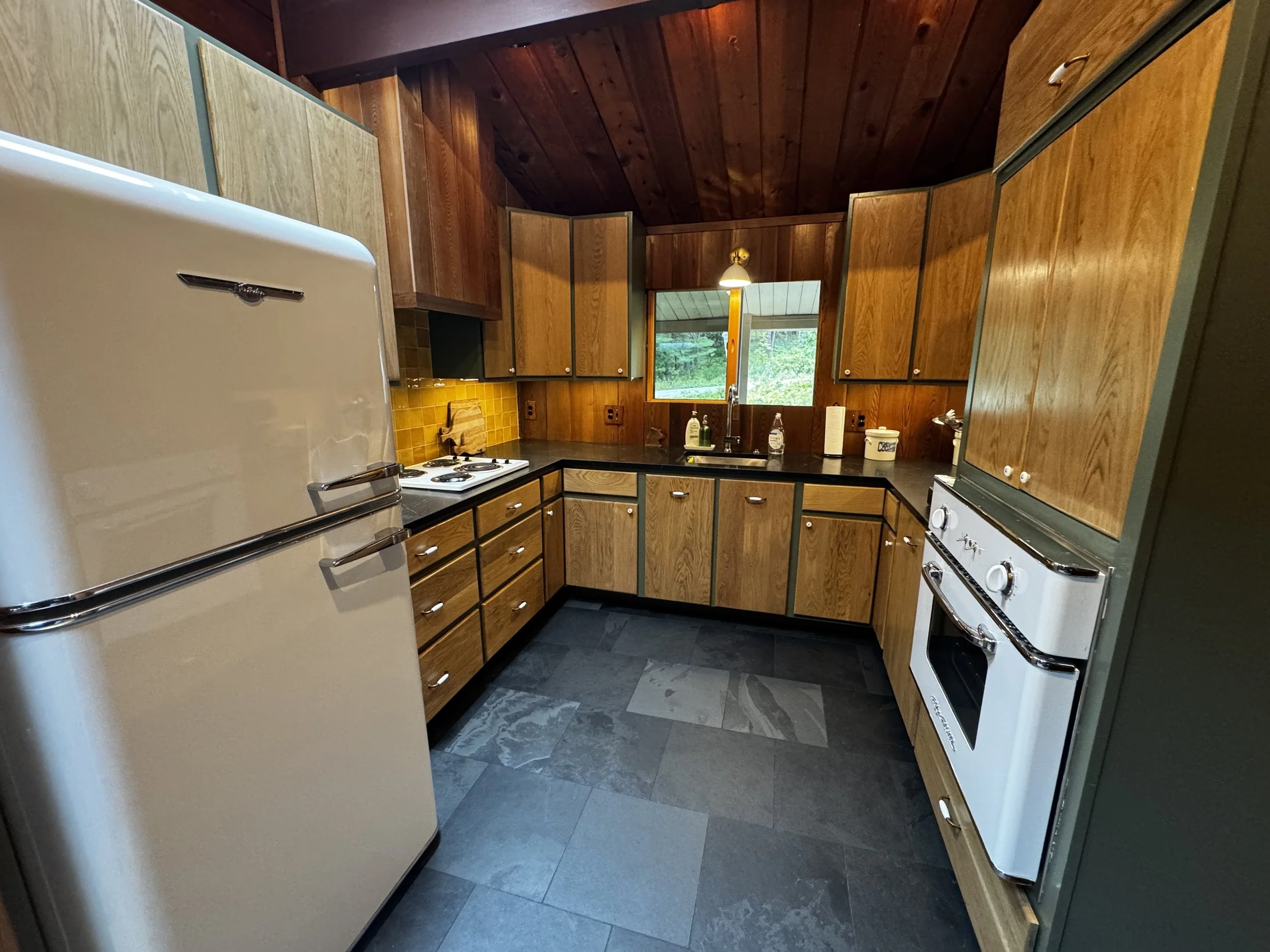 kitchen ski chalet mid century modern black tile yellow tile custom cabinetry small space retro