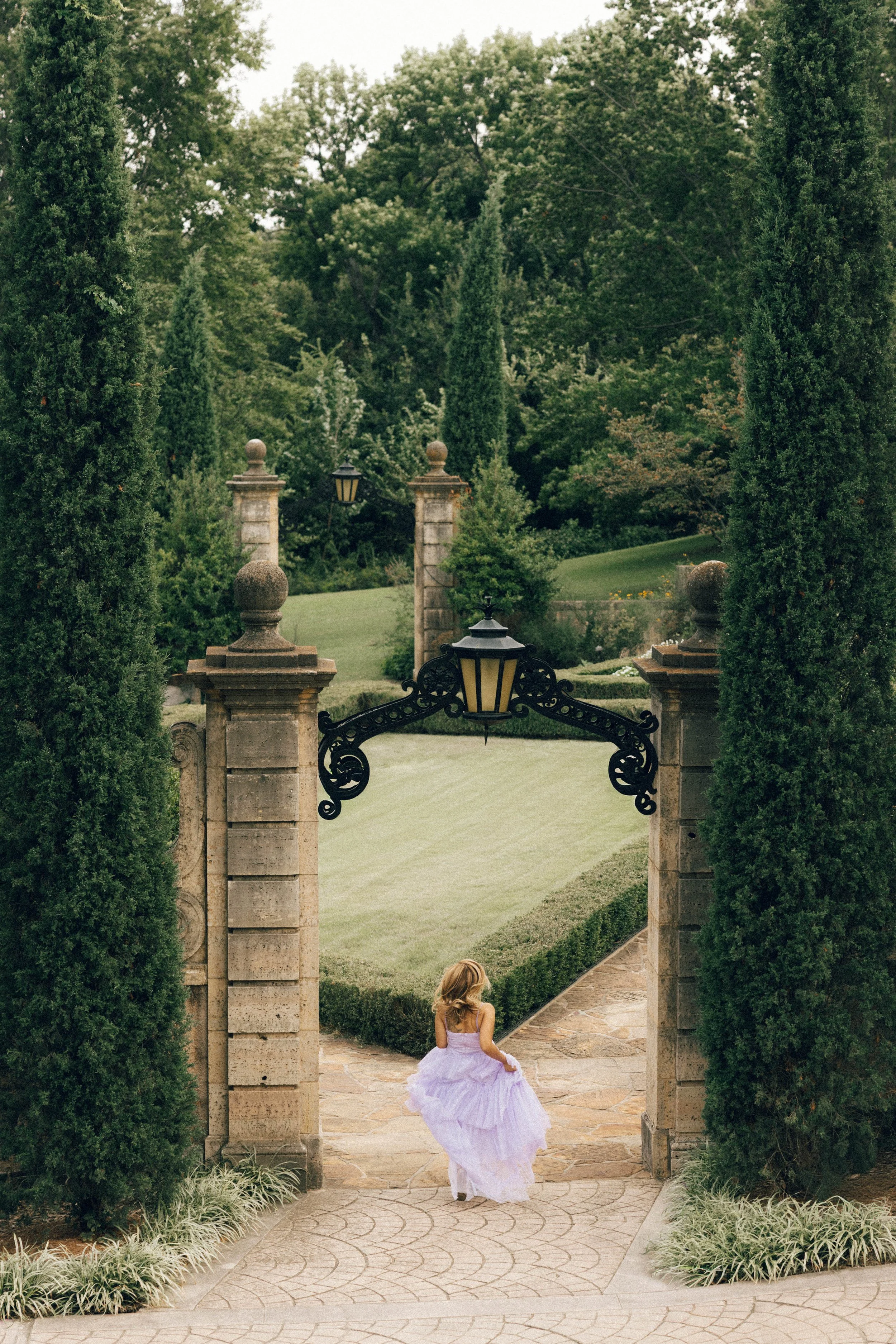 Bird’s-eye view of a bride at Philbrook Museum of Art. A nostalgic, fairy-tale wedding photography shot featuring the lush gardens and grand architecture of Tulsa's premier European-style venue