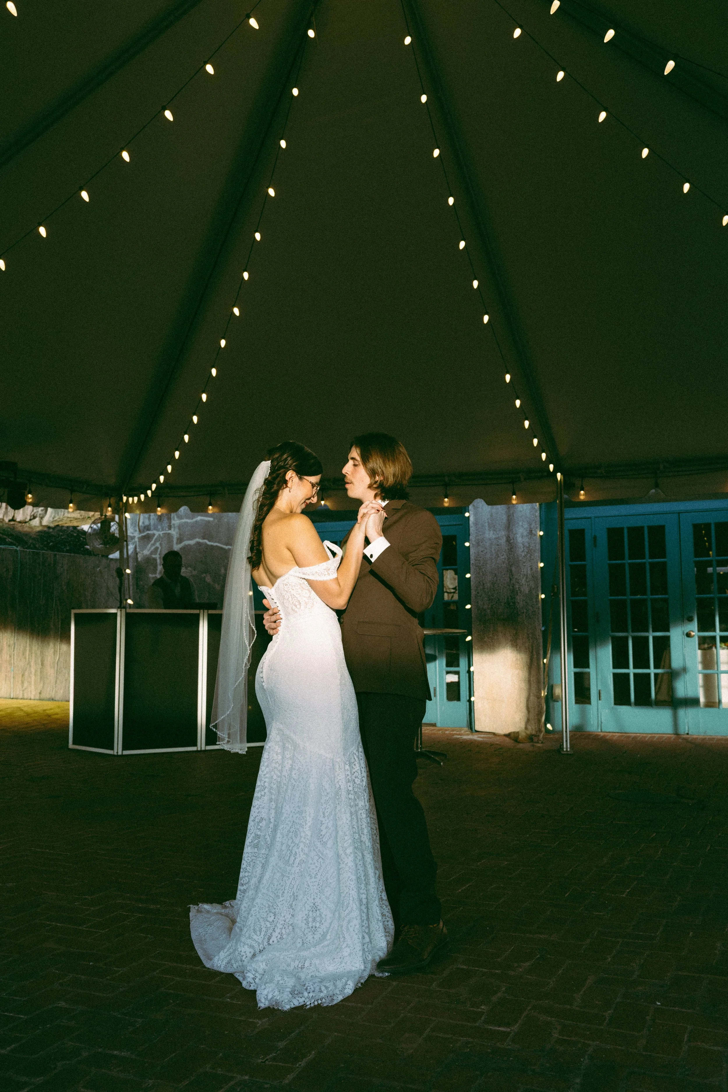a romantic and nostalgic first dance at the Dresser Mansion, in film. This soulful wedding photo features grainy textures, deep shadows, and a timeless, fashion-forward aesthetic in Tulsa
