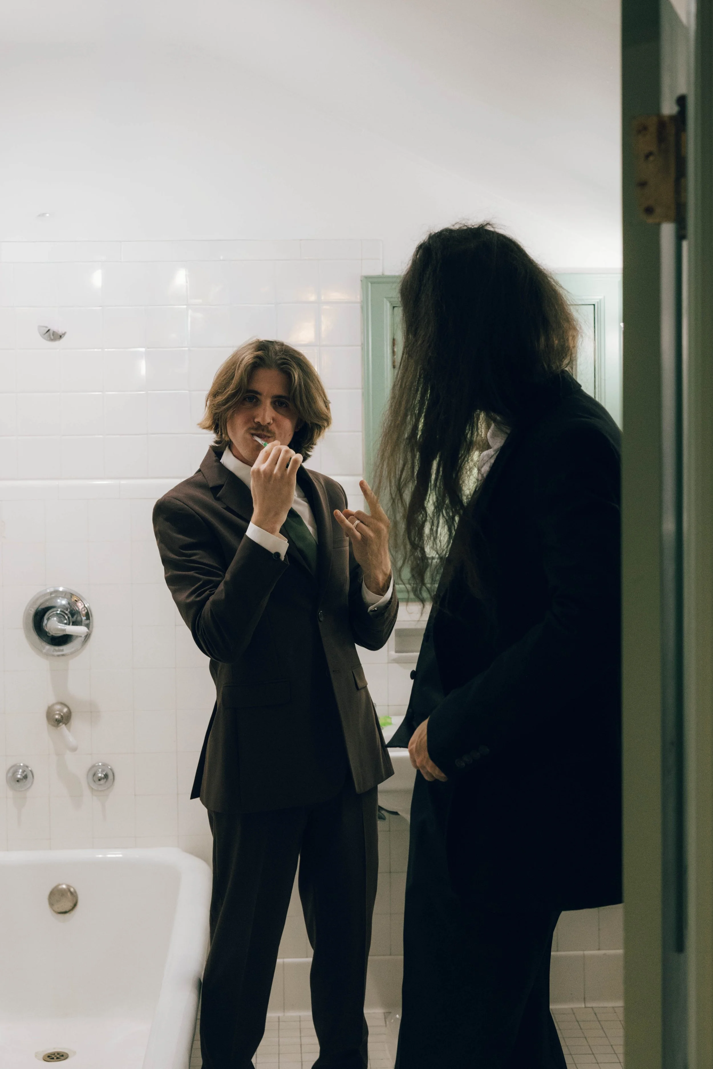 A candid, documentary style  groom portrait in the Dresser Mansion's groom's suite. A nostalgic moment before the celebration