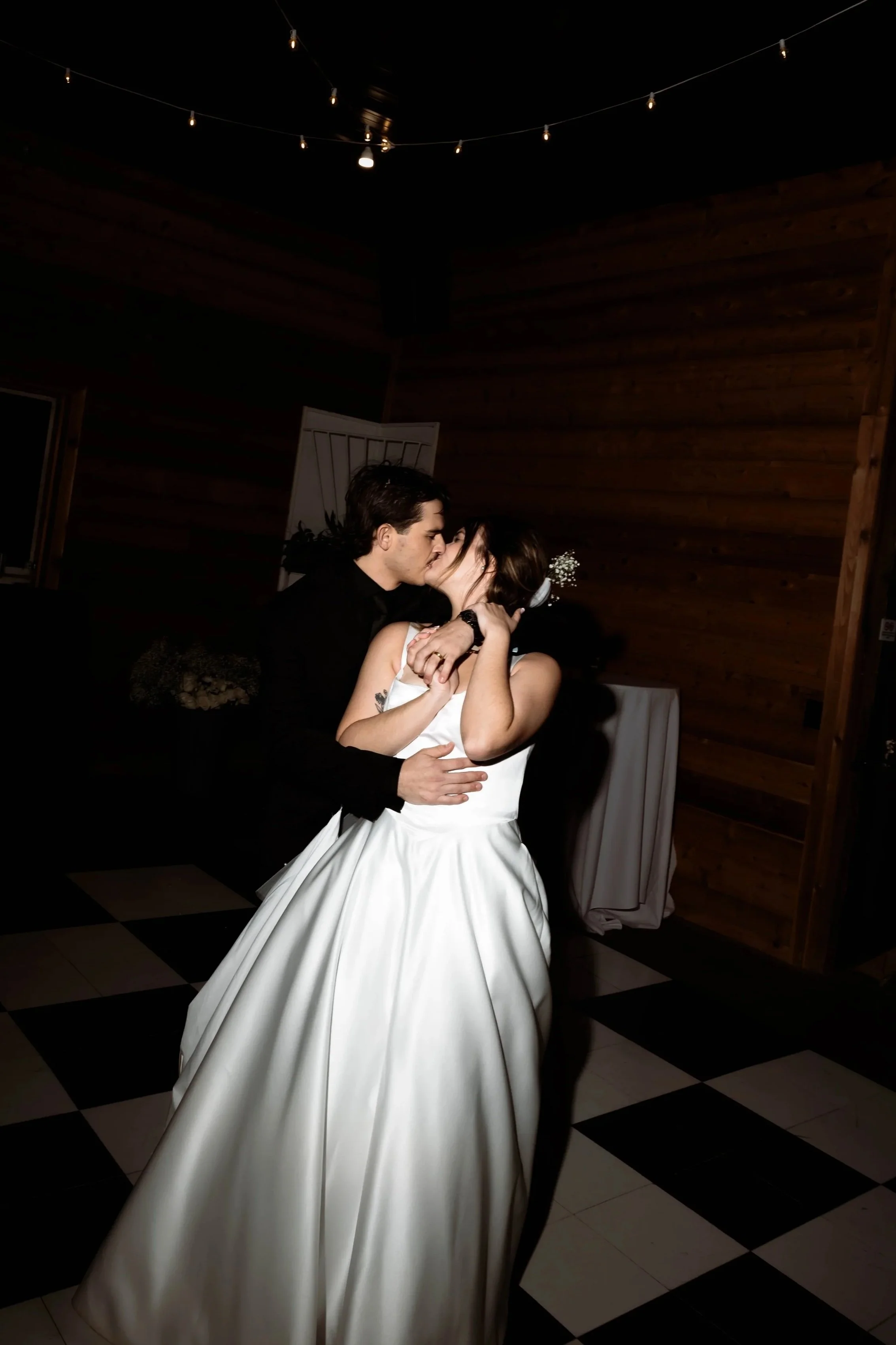 newlyweds kissing, editorial lighting
