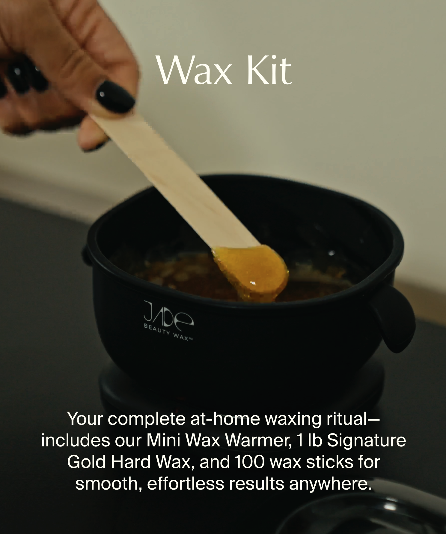 A hand with black-painted nails holding a wooden spatula stirring wax in a black wax warmer labeled 'Jade Beauty Wax.' The image promotes a DIY waxing kit.