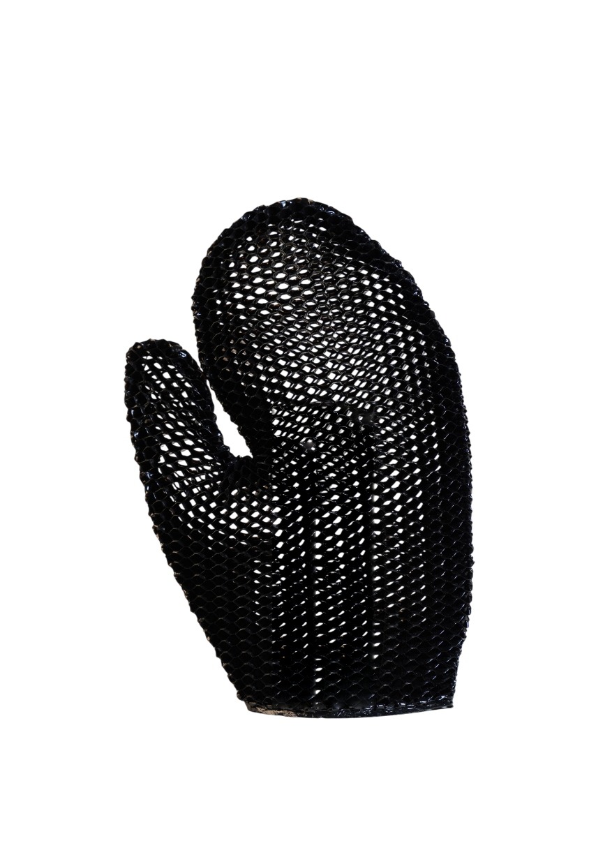 A dark-colored oven mitt made of textured material with a honeycomb pattern, isolated on a black background.