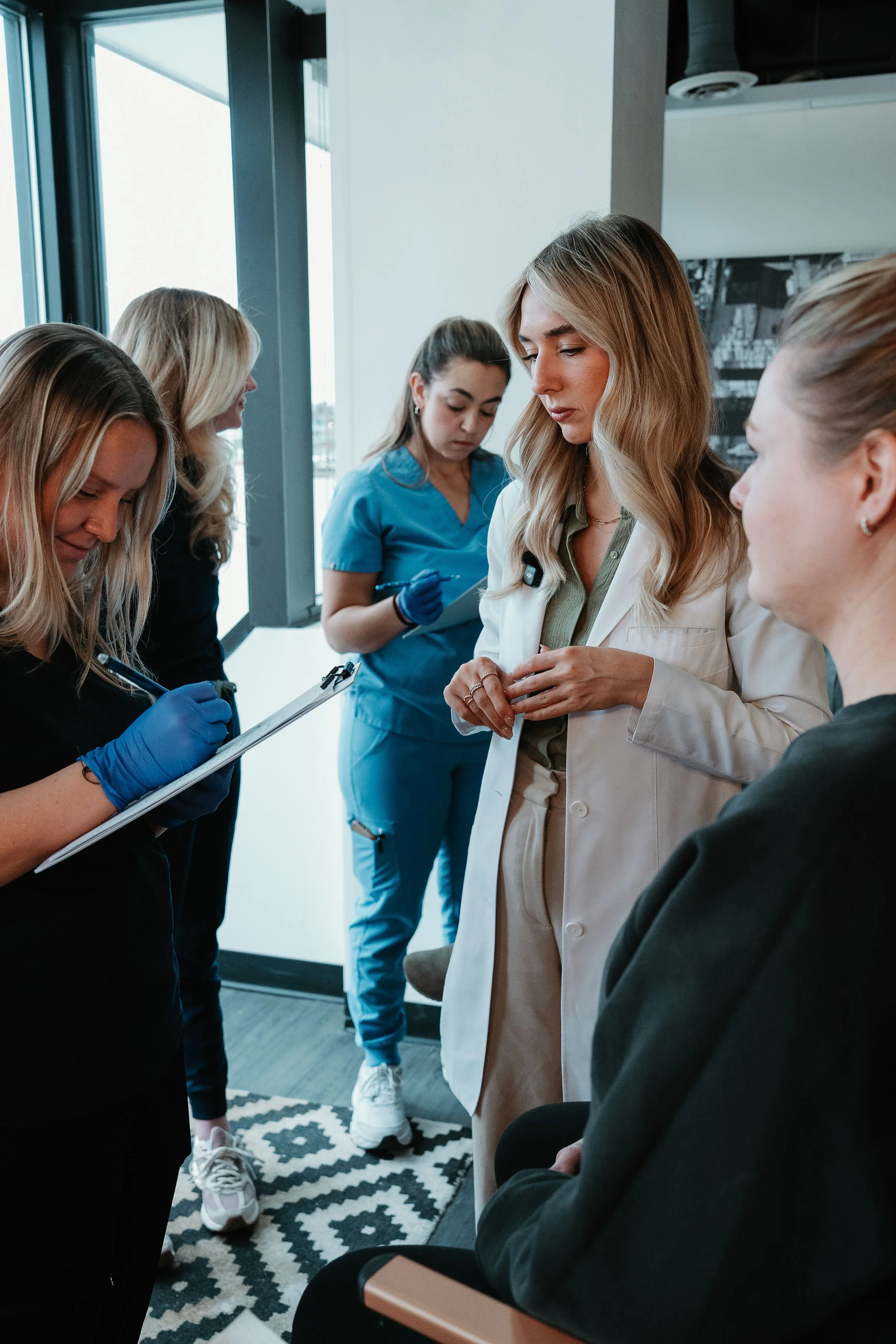 Group of medical professionals, including nurses and a doctor, having a discussion in a healthcare setting.