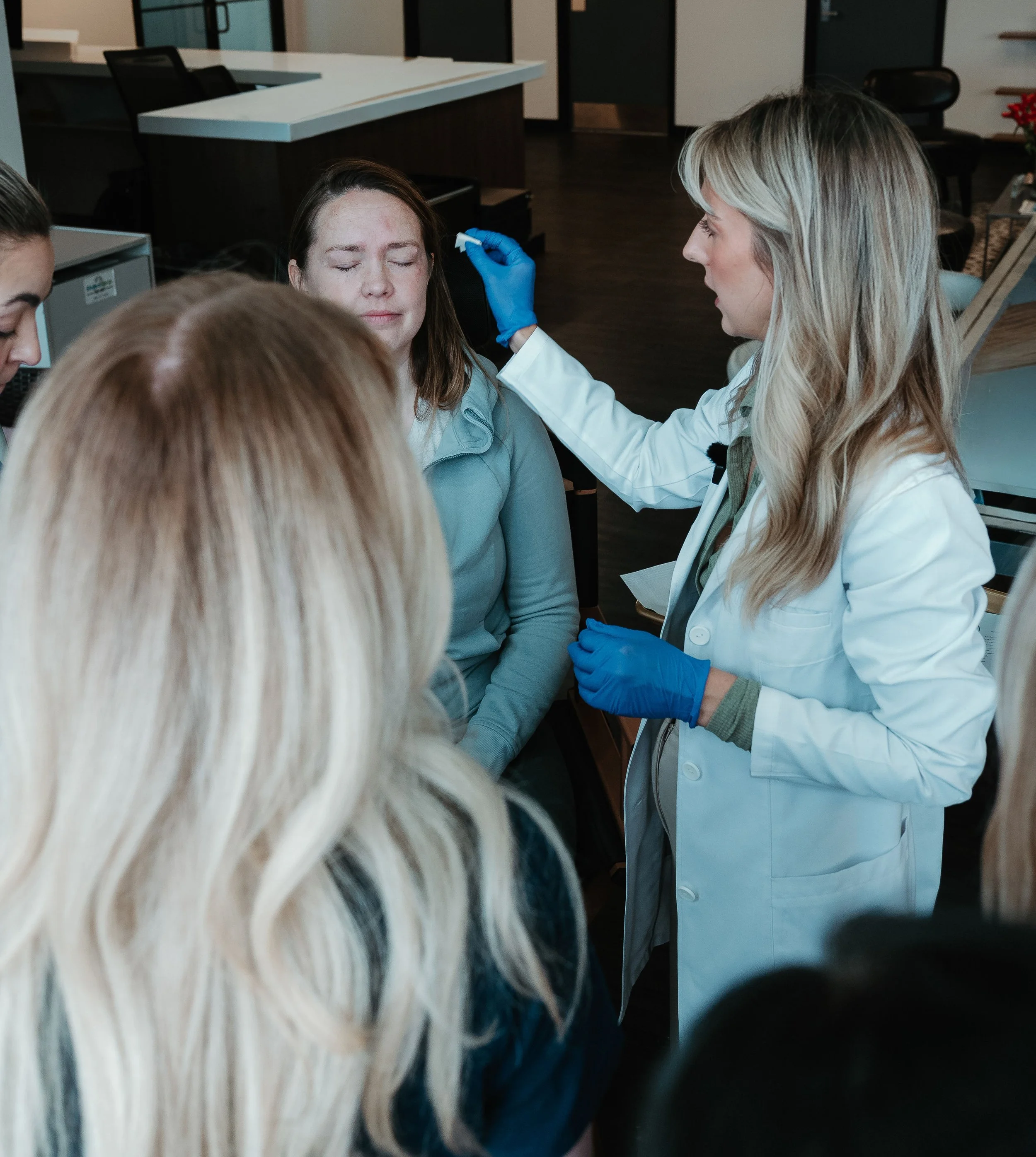 Medical professional administering a vaccination to a woman in a clinic.
